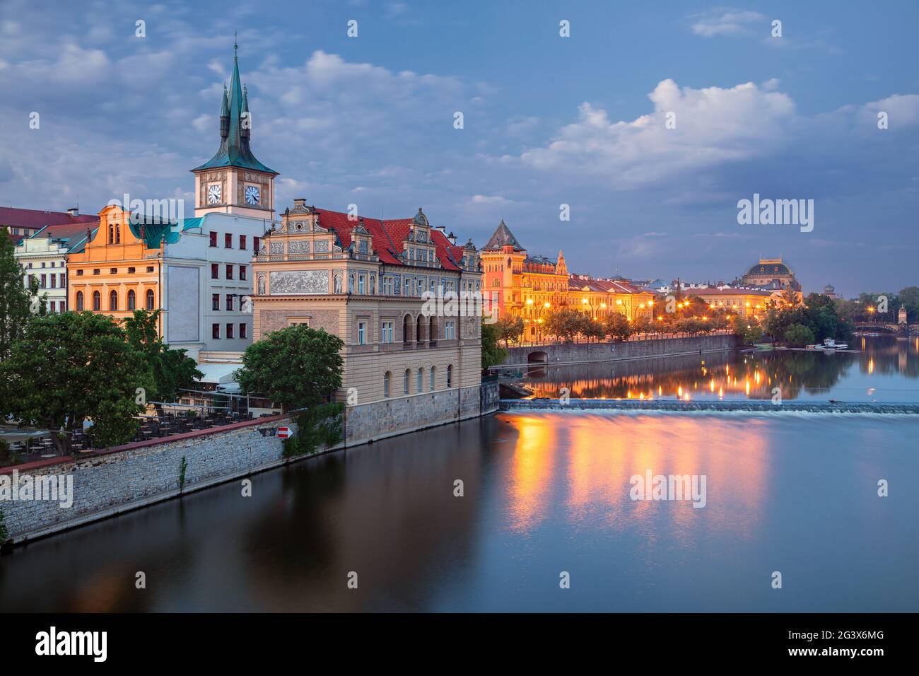 Prague Riverside. Cityscape image of Prague riverside with Old Town Water Tower at twilight blue hour. Stock Photo