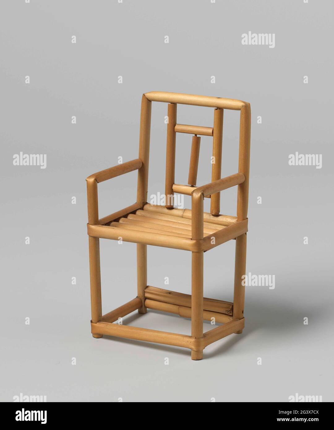 Chair of braid, with geometric motifs. Chair made from curved, and on wooden pennettes racing rod reeds. The backrest with geometric motifs. The legs are interconnected with cross rules. The seat is made of five half reed bars confirmed in the width. Stock Photo