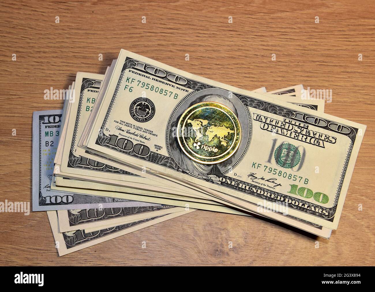 Ripple XRP Gold crypto coin on a bundle with dollars. The concept of  investing money in cryptocurrency and making a profit due to the fall in  the doll Stock Photo - Alamy