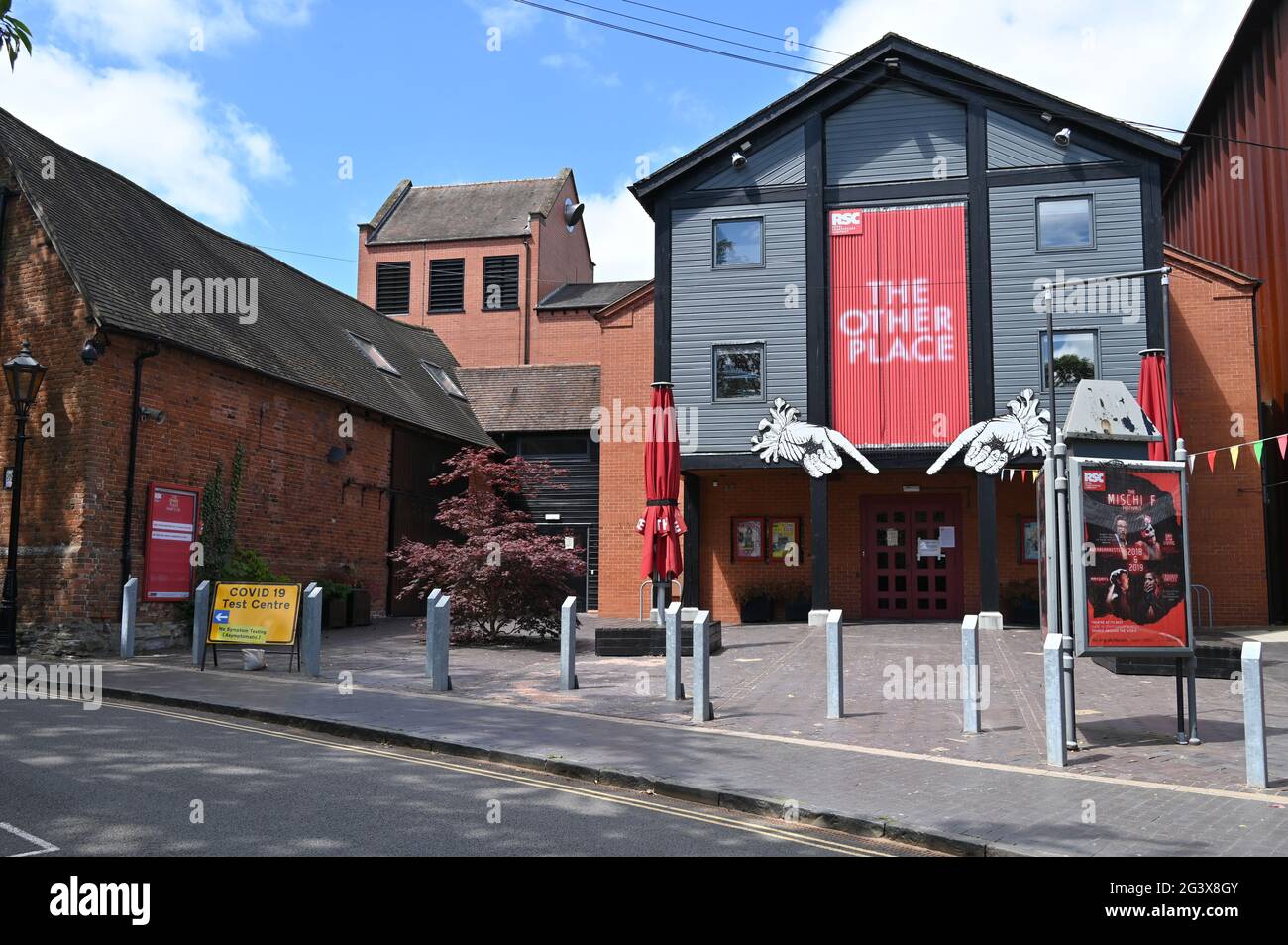 The Other Place Theatre, Waterside in the Warwickshire town of Stratford upon Avon. A sin pointing the way to a Covid-19 testing centre is on the left Stock Photo