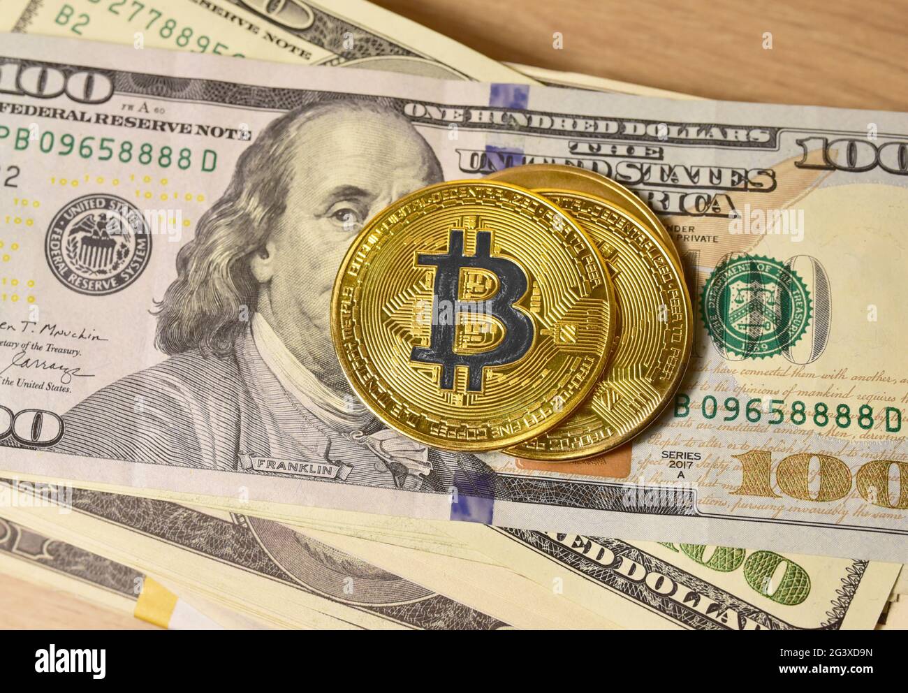 Bitcoin coins on a bundle with dollars. The concept of investing money in  cryptocurrency and making a profit due to the fall in the dollar exchange  ra Stock Photo - Alamy
