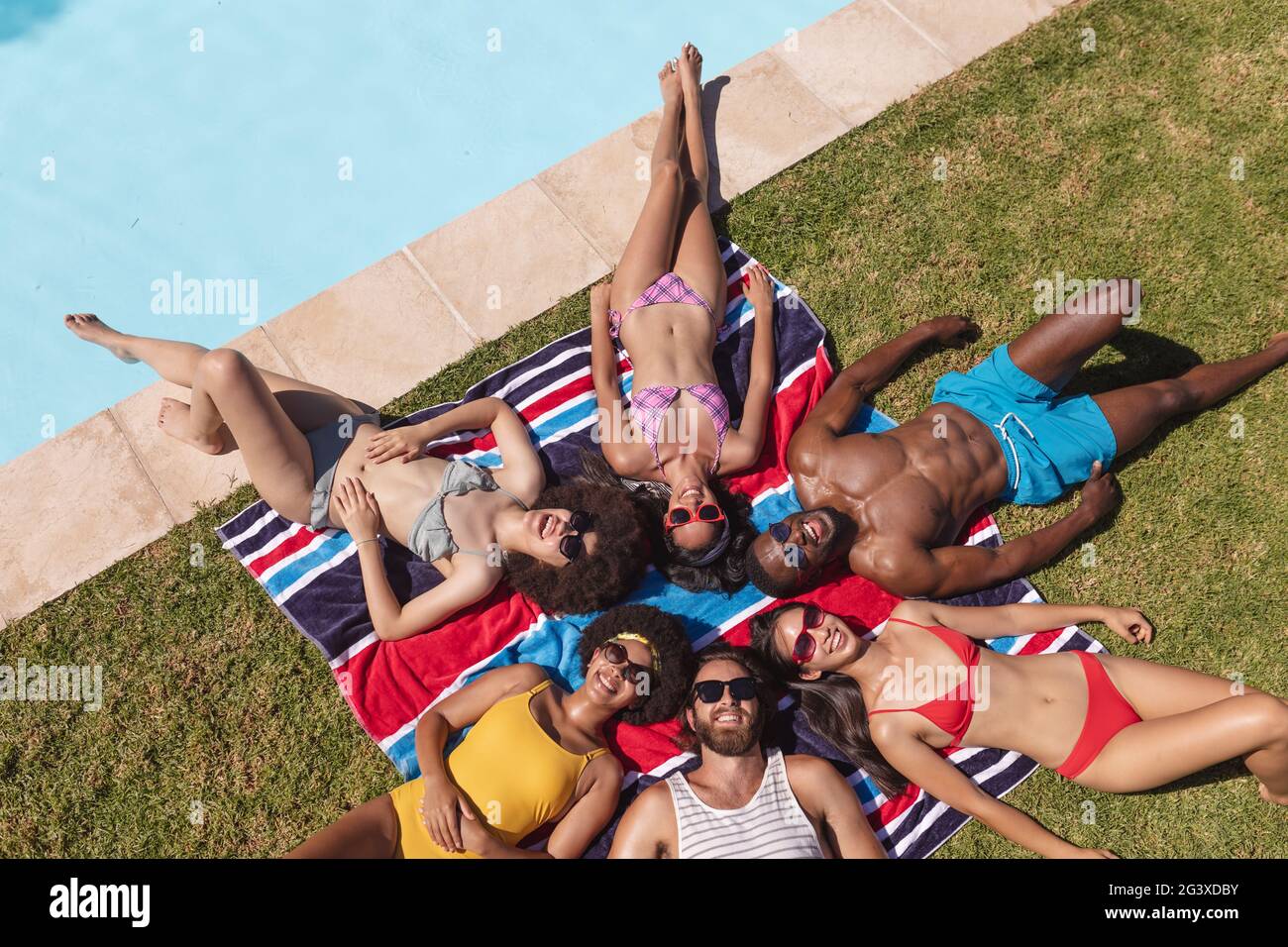 female-friends-sunbathing-on-the-beach-hi-res-stock-photography-and