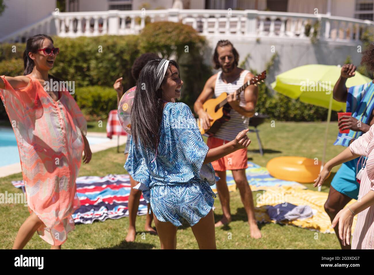 Diverse group of friends having fun and dancing at a pool party Stock ...