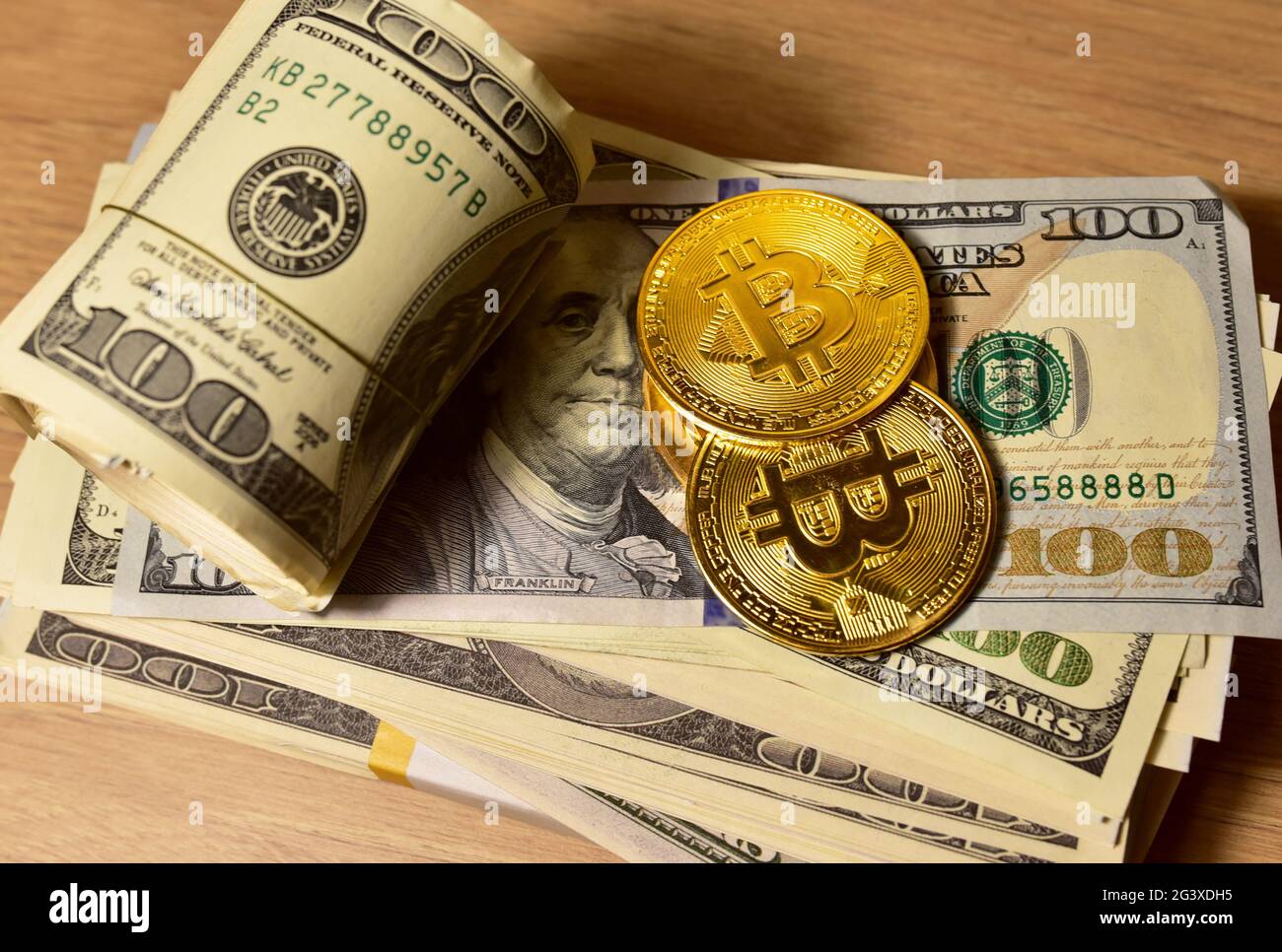Bitcoin coins on a bundle with dollars. The concept of investing money in  cryptocurrency and making a profit due to the fall in the dollar exchange  ra Stock Photo - Alamy