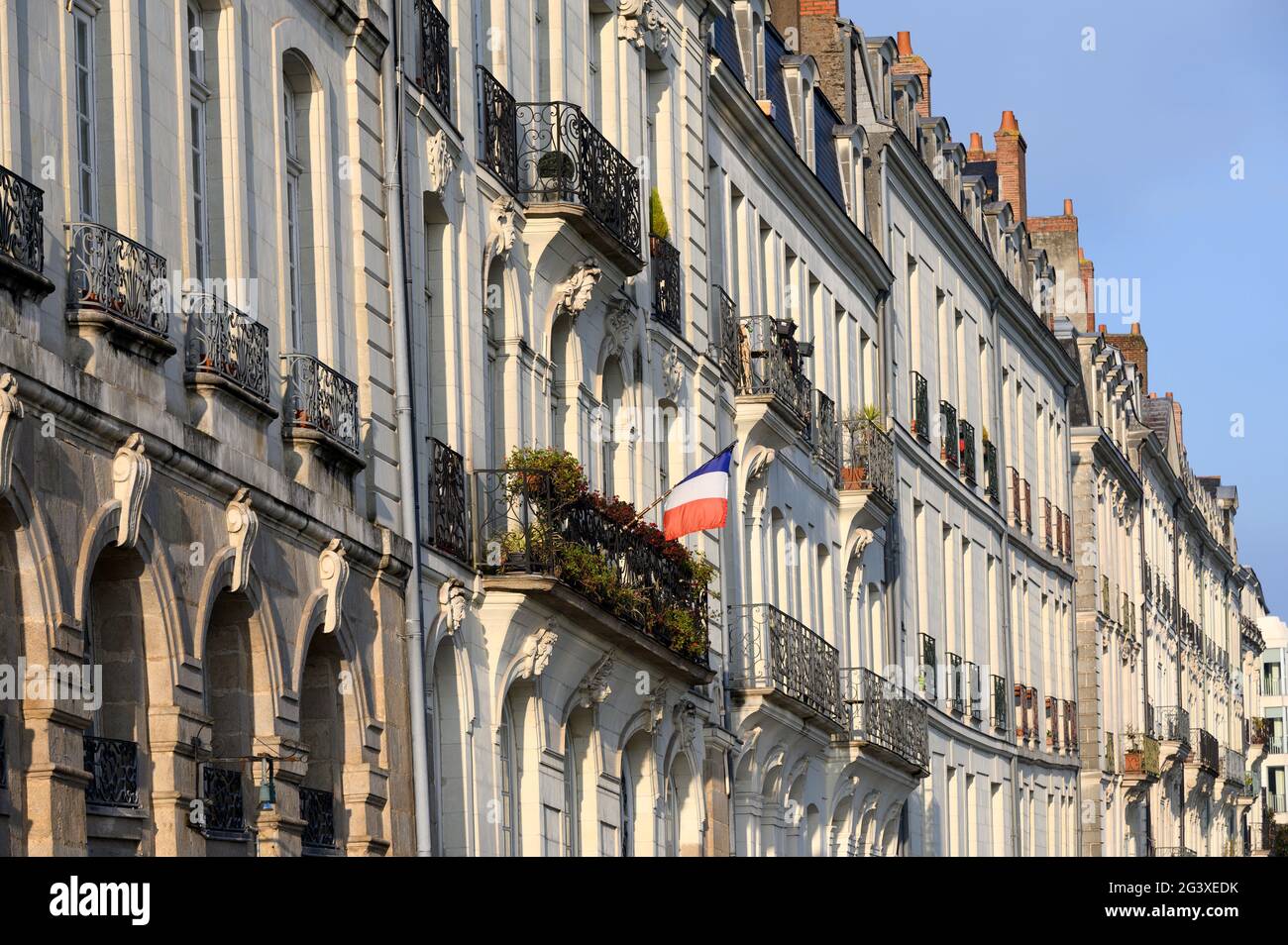 Nantes (north western France): “quai Turenne” quay on the 'Ile Feydeau' river island, in the city centre. Tricolor flag on a building facade, on a bal Stock Photo