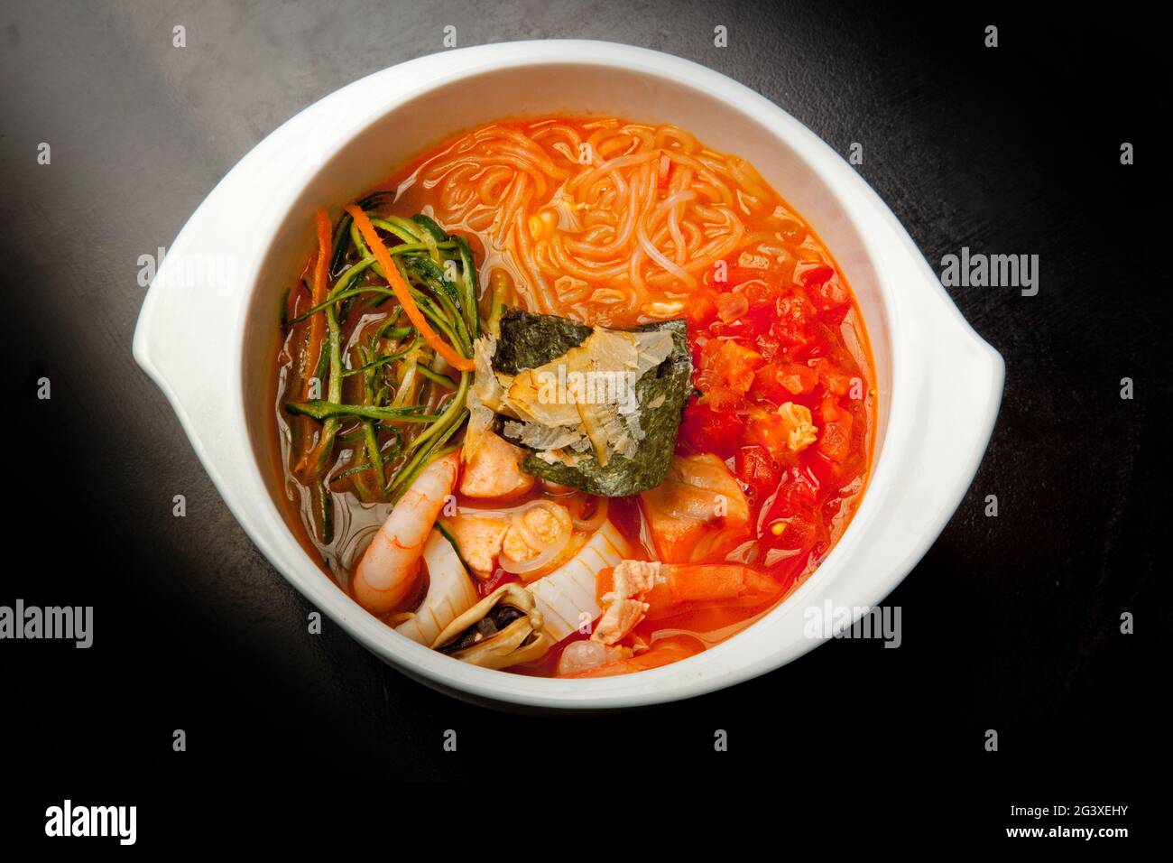 Traditional Japanese miso soup with seaweed and fish. Closeup, top
