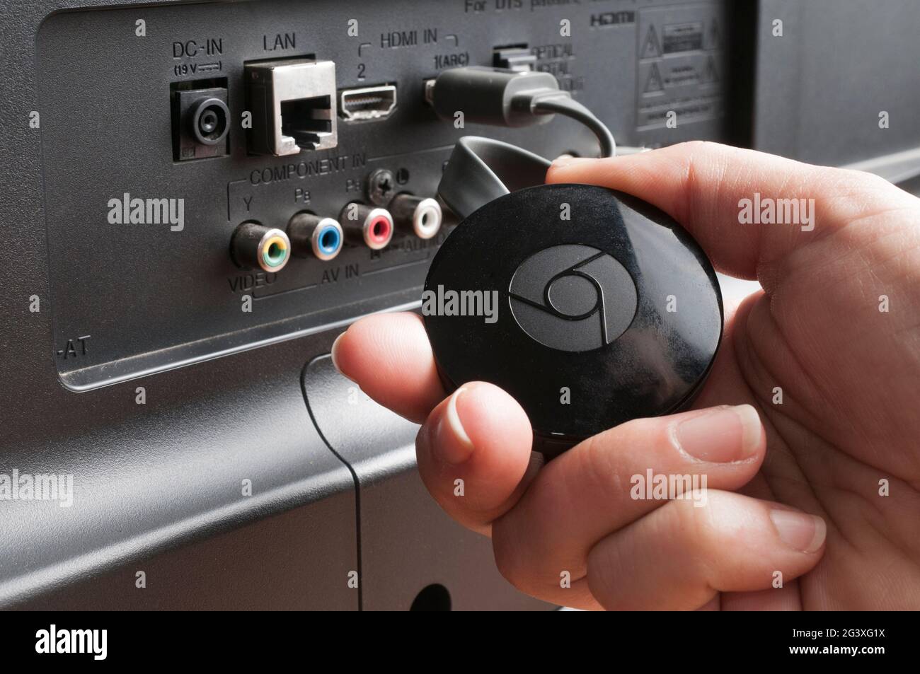 Carrara, Italy - June 18, 2021 - Woman show a google chromecast device  connected to a tv Stock Photo - Alamy