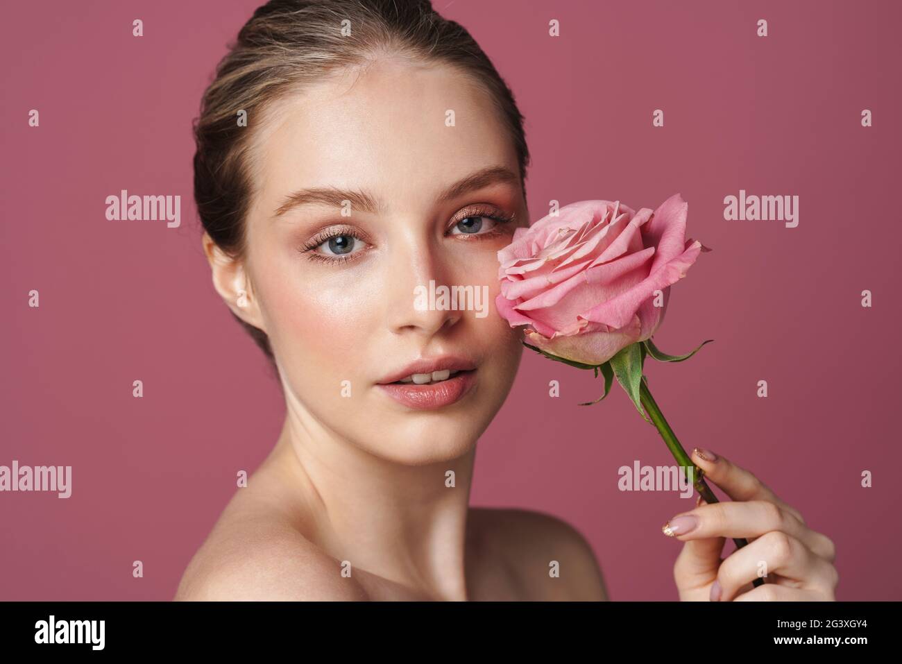 Close up beauty portrait of an attractive young woman posing with a ...