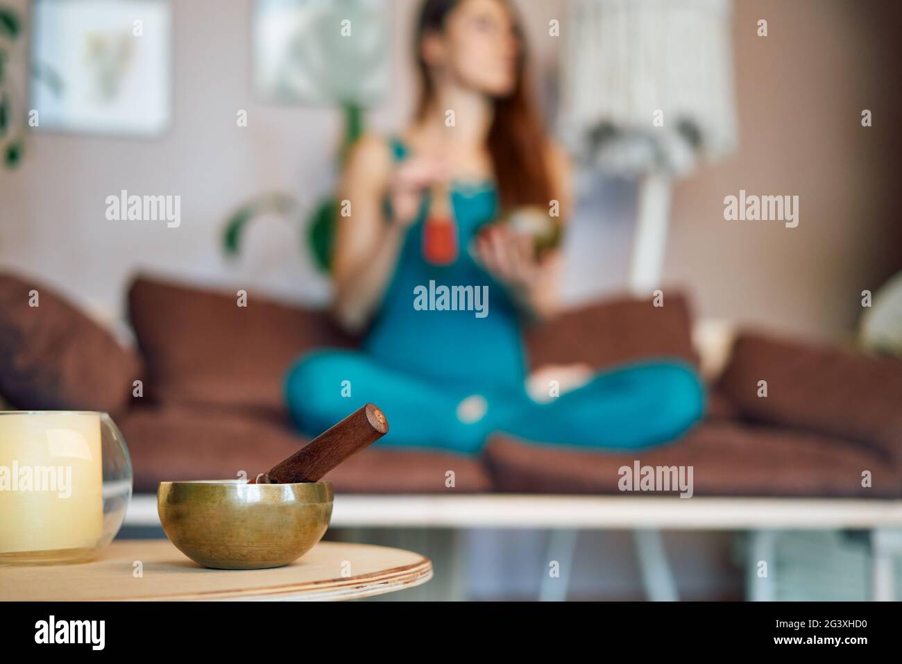 Tibetan singing bowl and woman practicing yoga on background Stock Photo