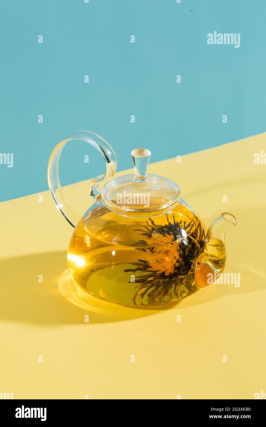Green tea. Blooming flower in glass teapot Stock Photo