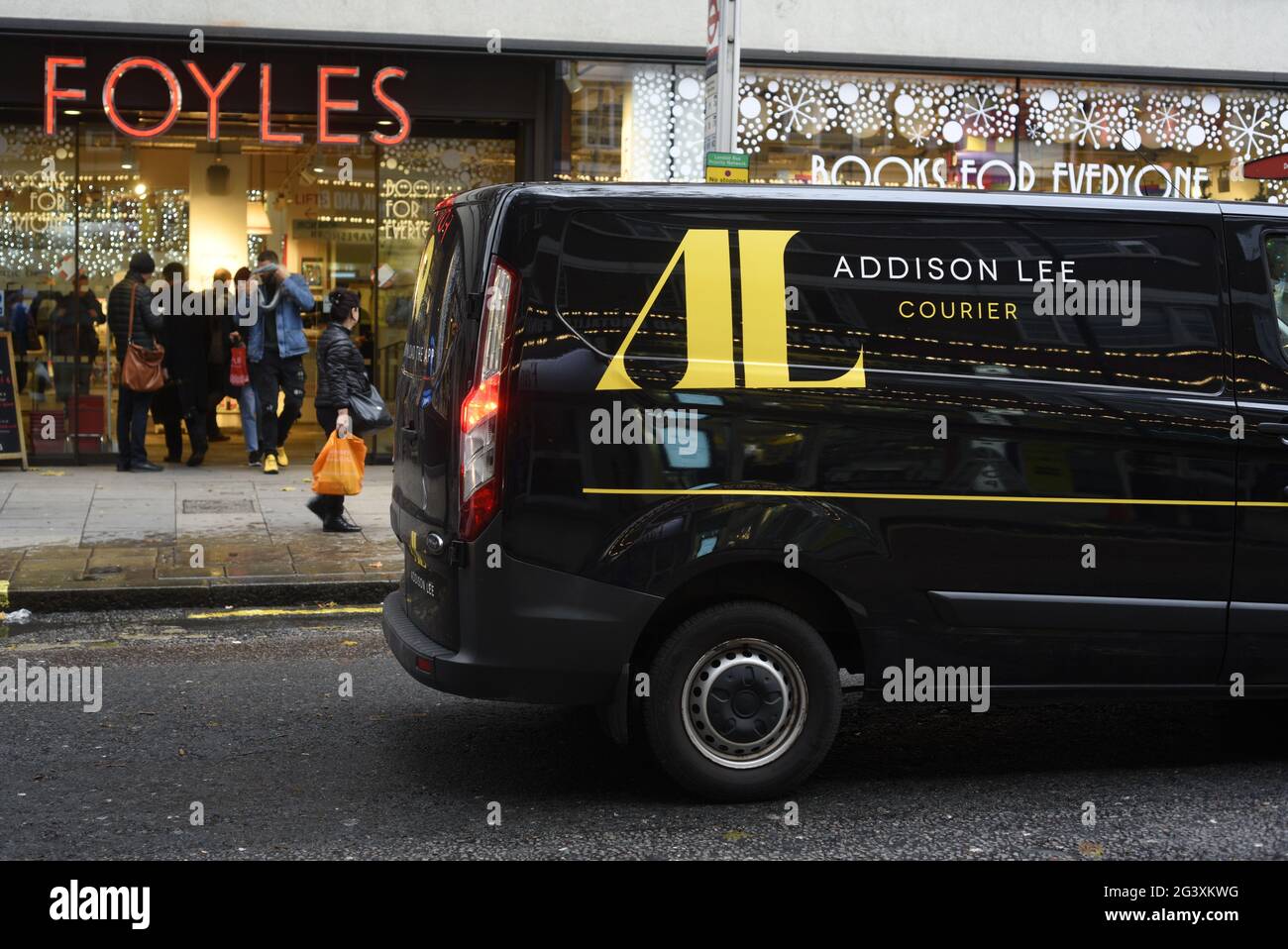 An Addison Lee courier van outside Foyles bookshop on Charing Cross Road, London Stock Photo
