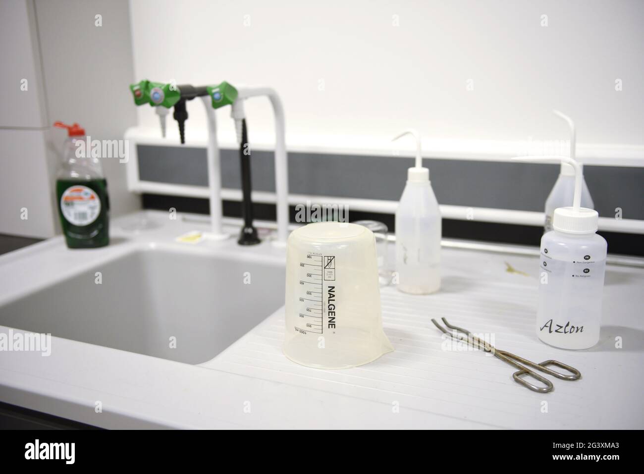 A deep sink in a commercial science lab / laboratory. With various containers. Selective focus. Stock Photo