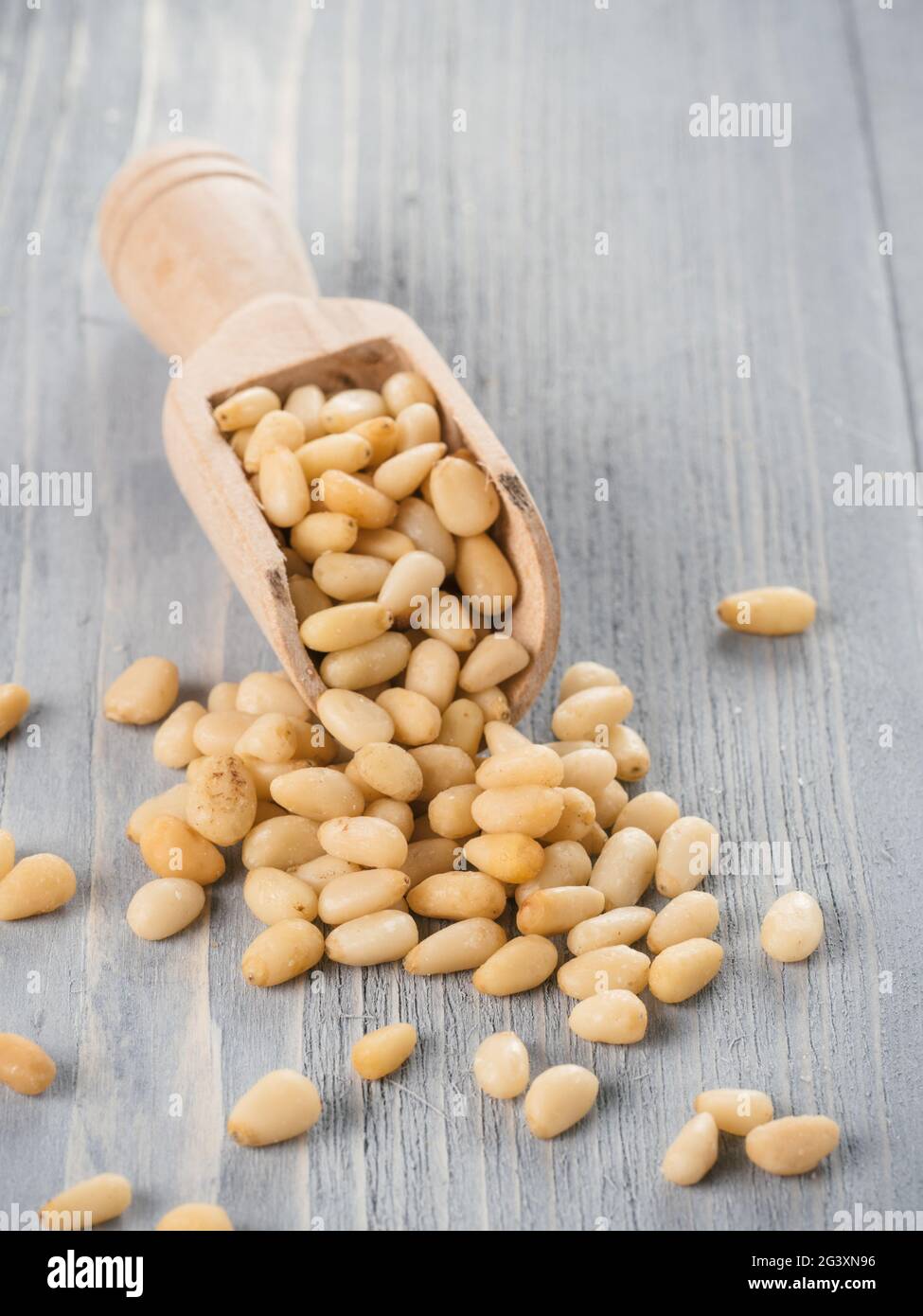Pine nuts on gray wooden background Stock Photo