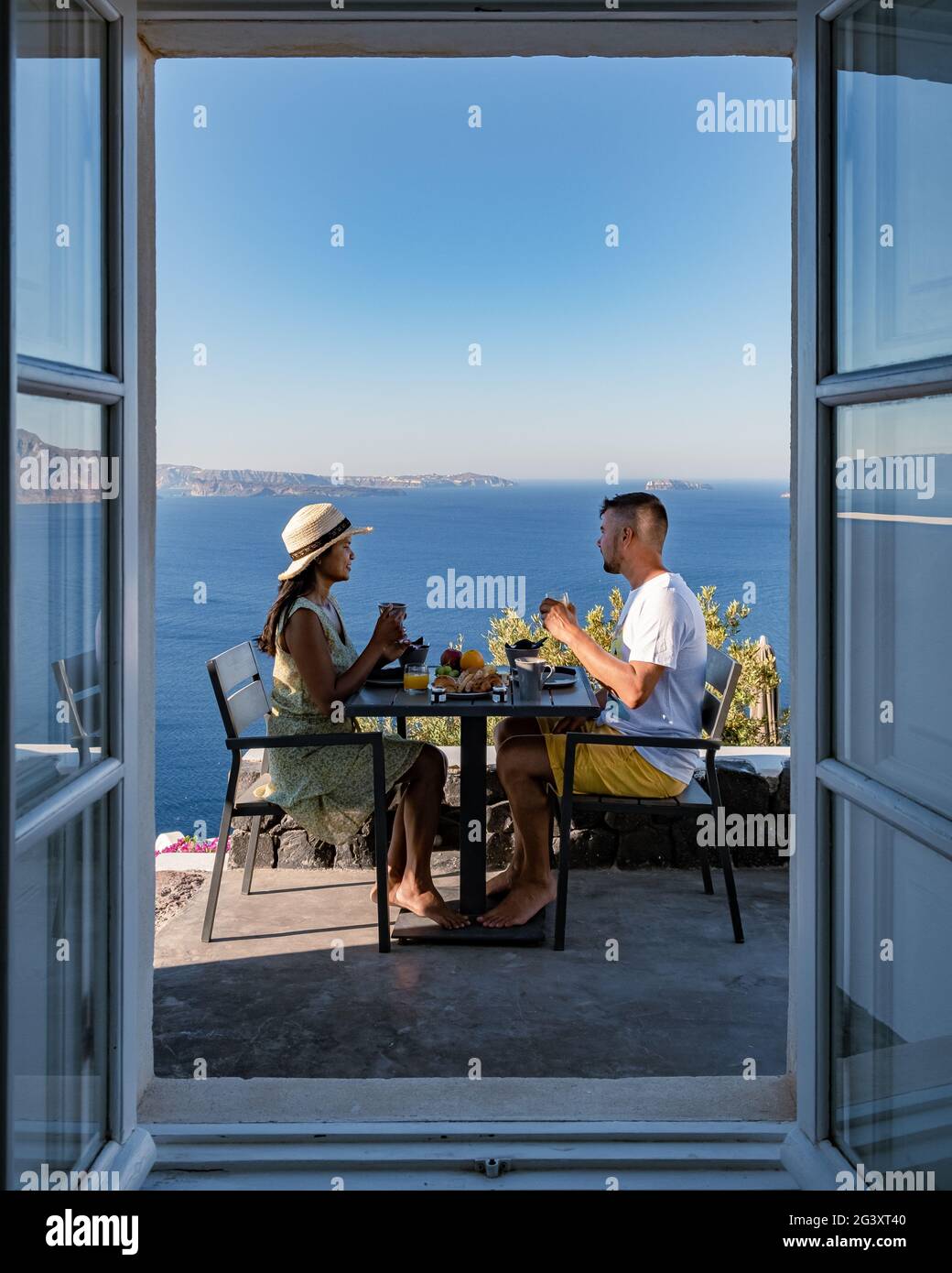 Santorini Greece, young couple mid age European and Asian on vacation at the Greek village of Oia Santorini Greece, luxury vacat Stock Photo