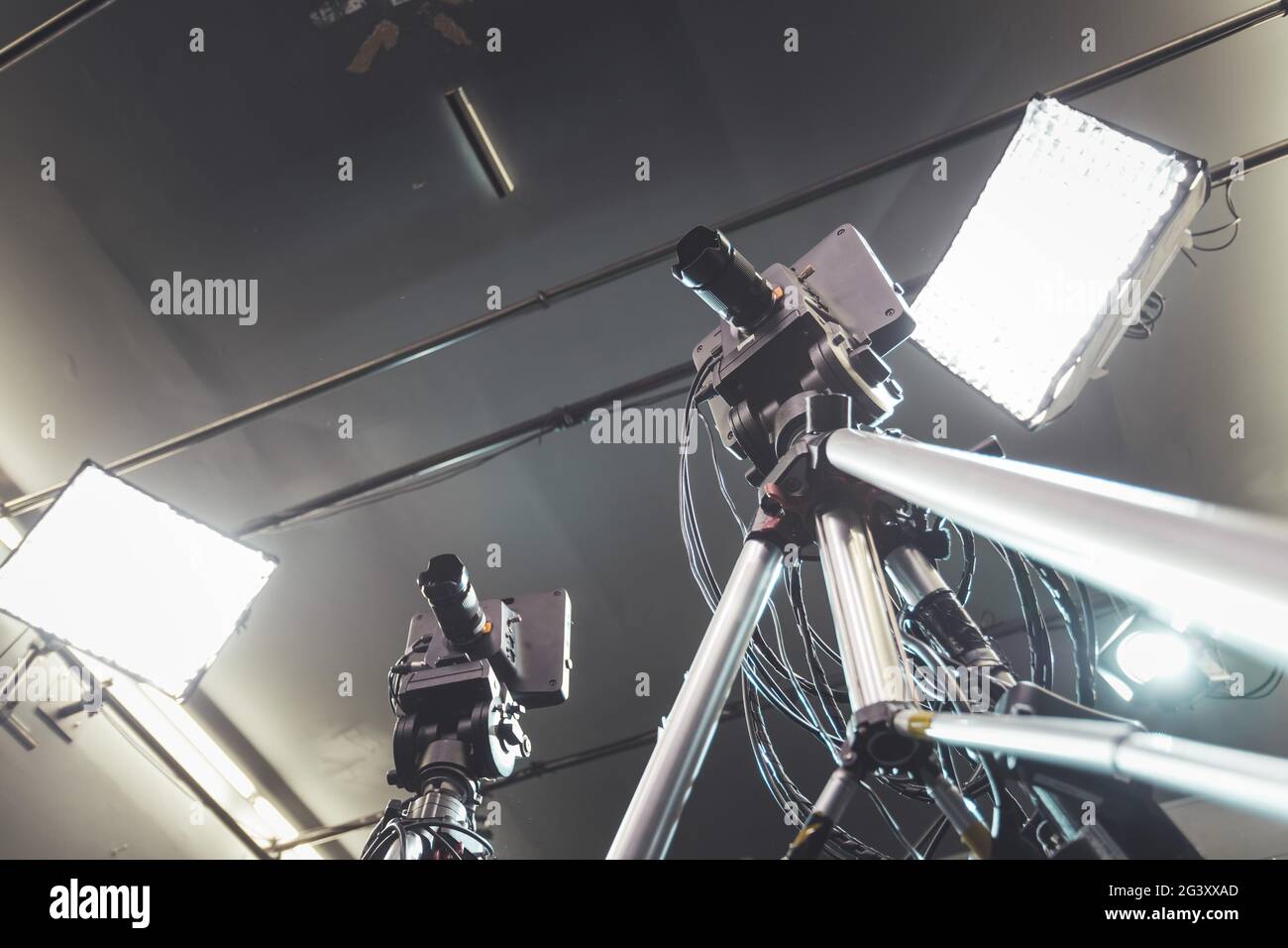 Film Camera Record Led Professional film camera on tripod, broadcasting studio, spotlights and ...