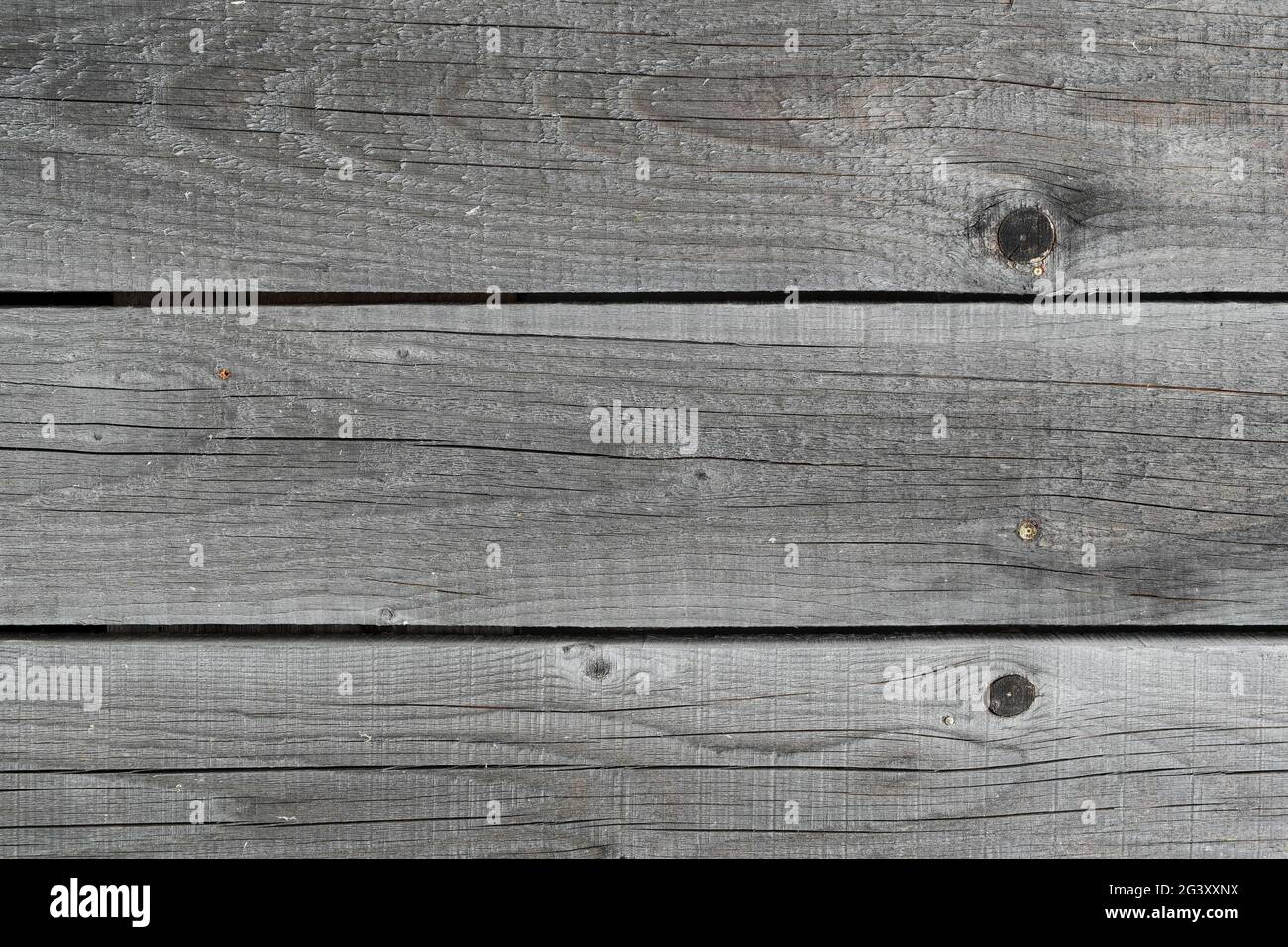 The texture of old rough wooden planks, cracked by time and weather. Stock Photo