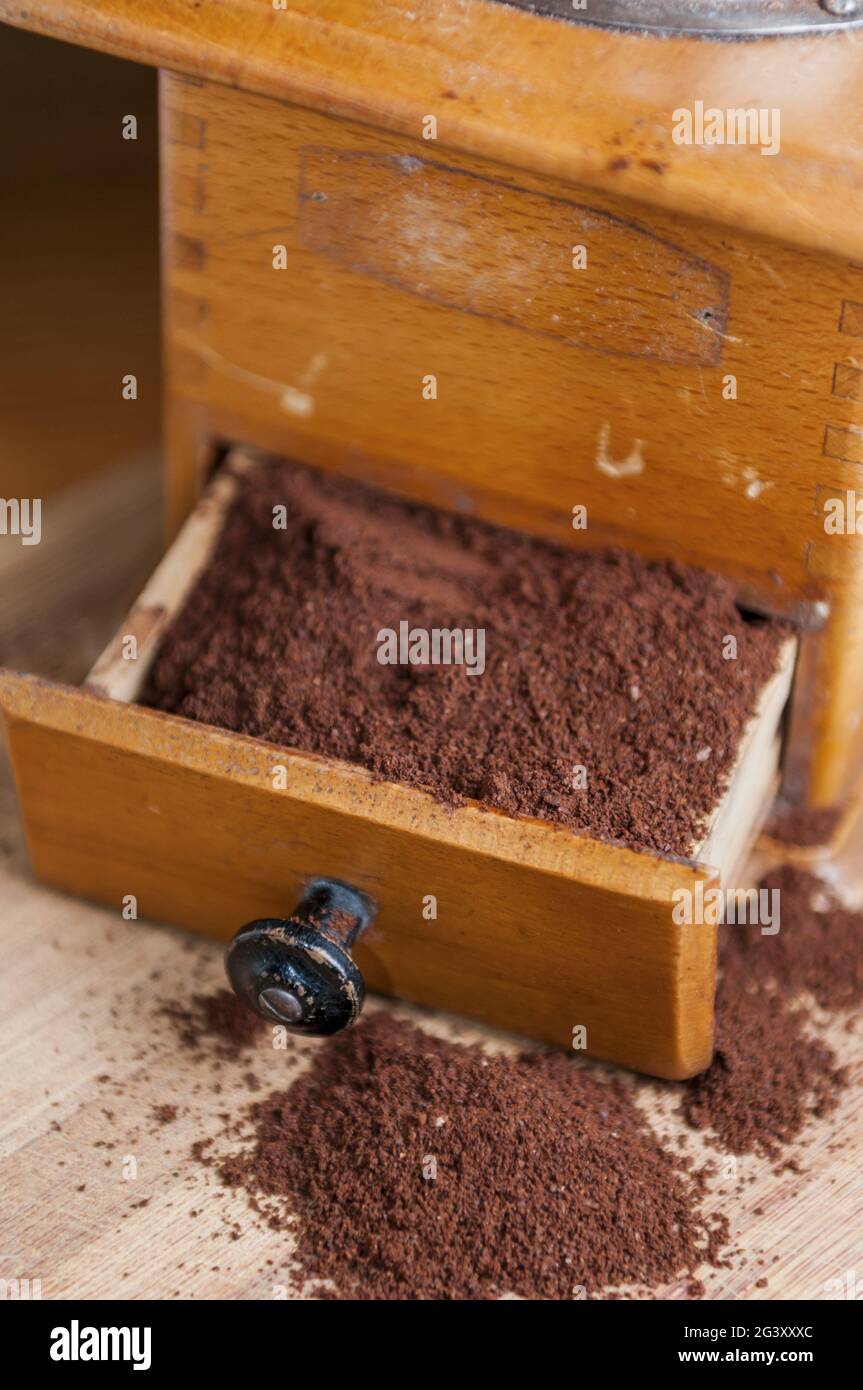 Coffee grinder with coffee powder vertical Stock Photo
