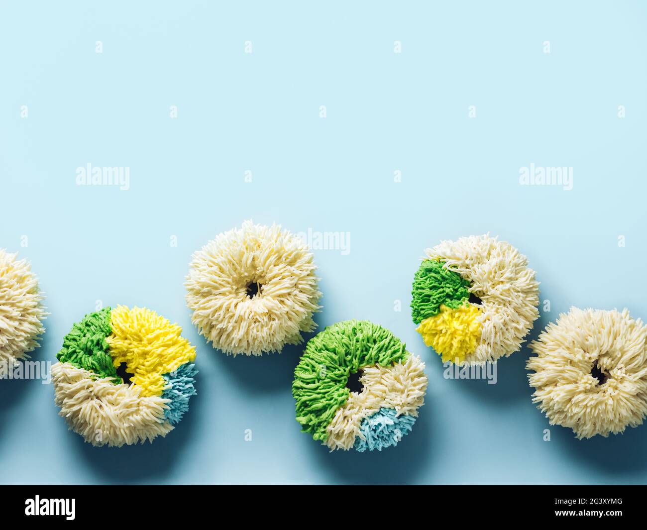 Shag donuts on blue background, copy space Stock Photo