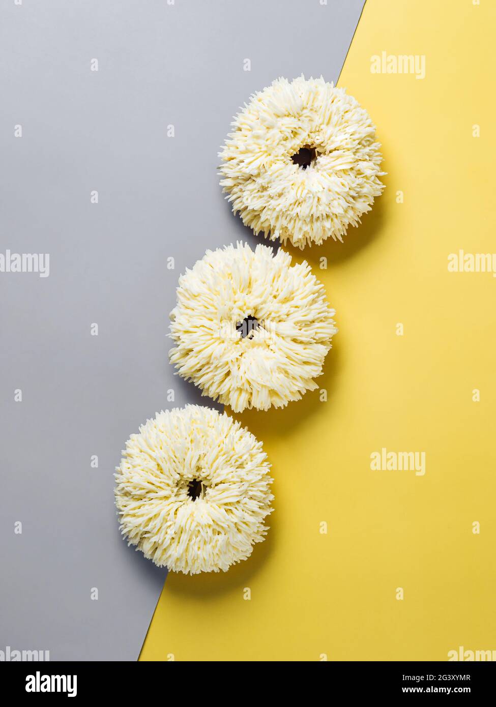 Shag donuts on yellow background, copy space Stock Photo