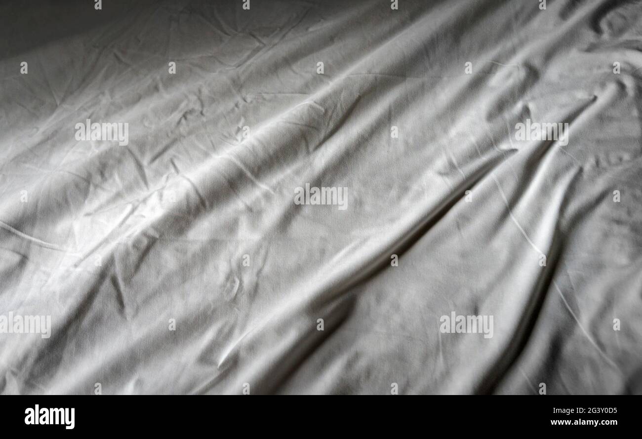 Crumpled bed linen in hotel Stock Photo