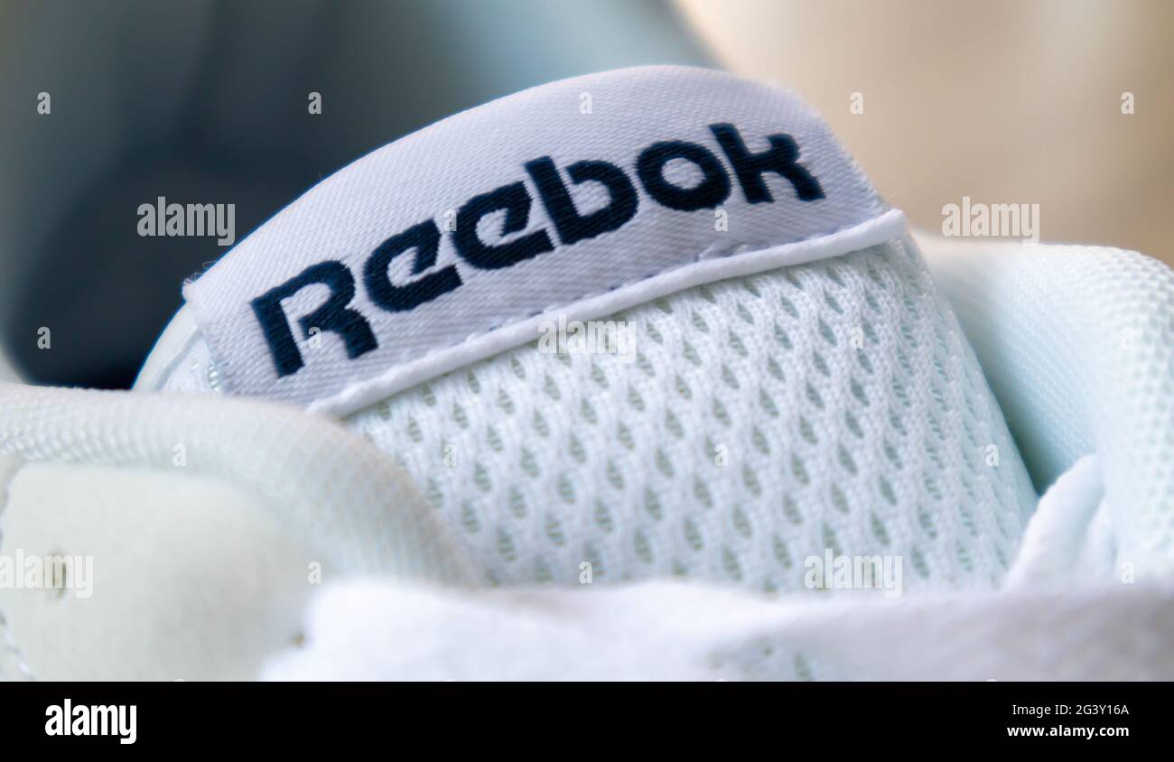 Sign on Reebok shoes. One of the world's largest sportswear and footwear  companies. New white sneakers with Reebok logo. The concept of sports and  cas Stock Photo - Alamy
