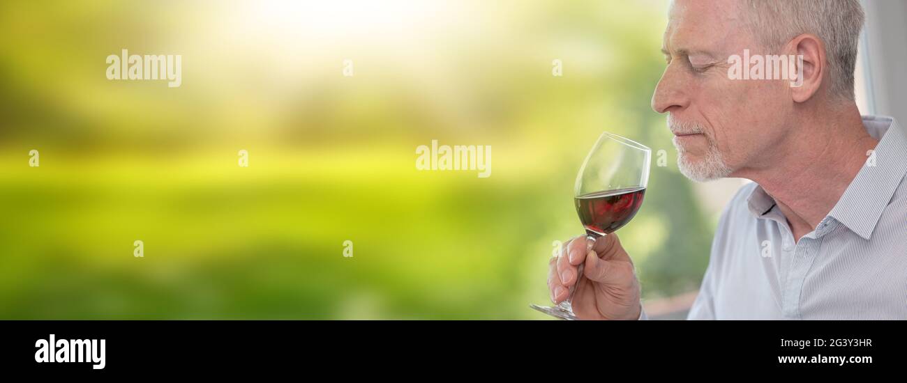 Senior man tasting red wine Stock Photo - Alamy