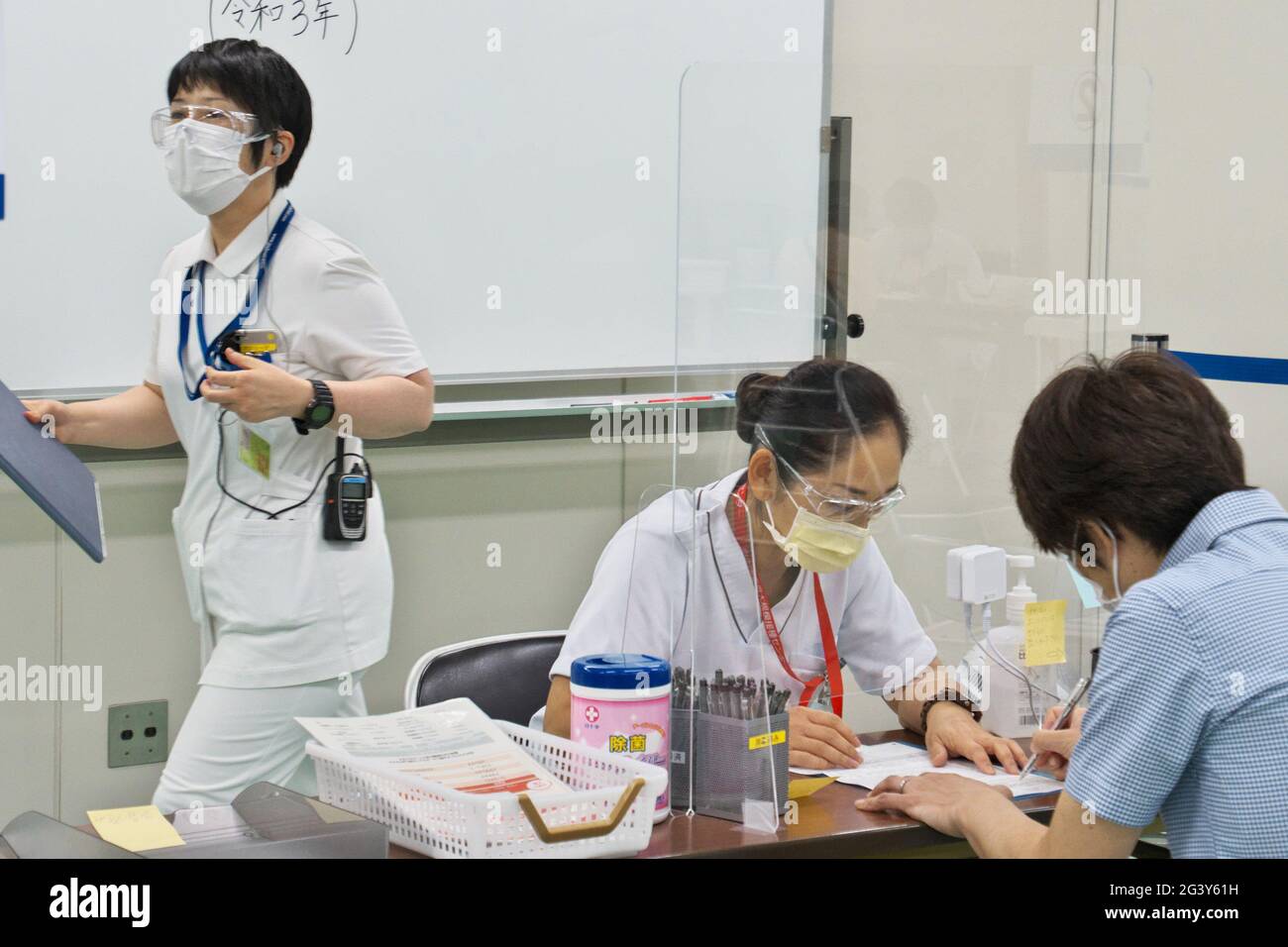 Tokyo, Japan. 18th June, 2021. A medical worker checks for vaccinators