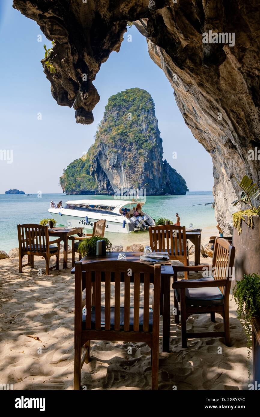 Dinner tables or luch on the beach Railay beach with a beautiful backdrop of Ko Rang Nok Island In Thailand Krabi Stock Photo