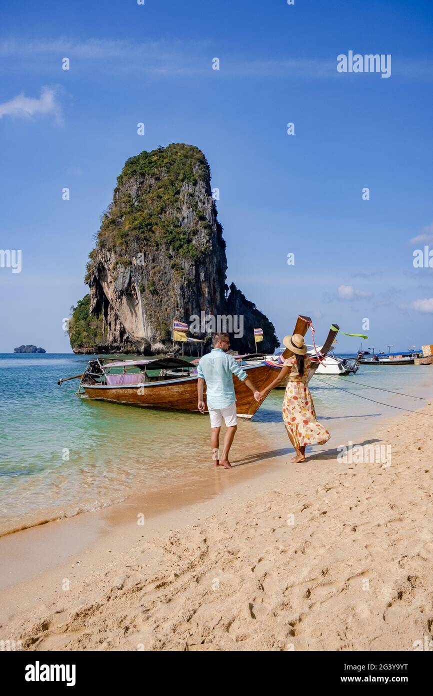 Couple mid age on tropical beach in Thailand, tourist walking on a white tropical beach, Railay beach with on the background lon Stock Photo