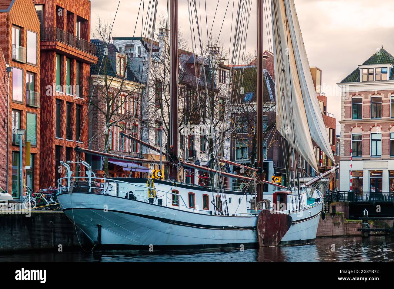 Old sailboat in a canal in the city center of Groningen, The Netherlands Stock Photo