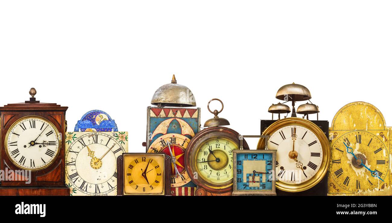 Collection of different vintage table clocks in a row isolated on a ...