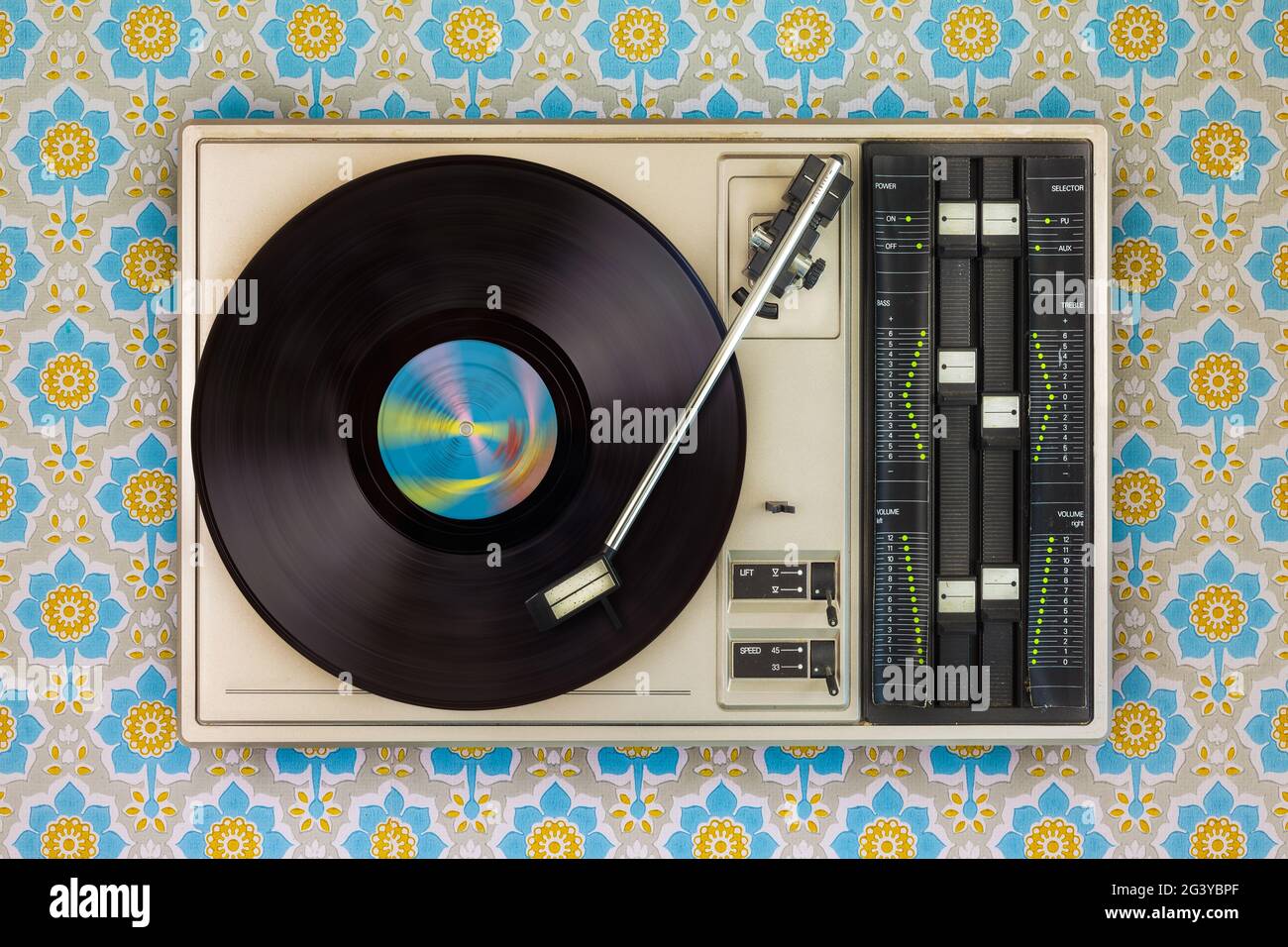 Old record player on top of flower wallpaper Stock Photo