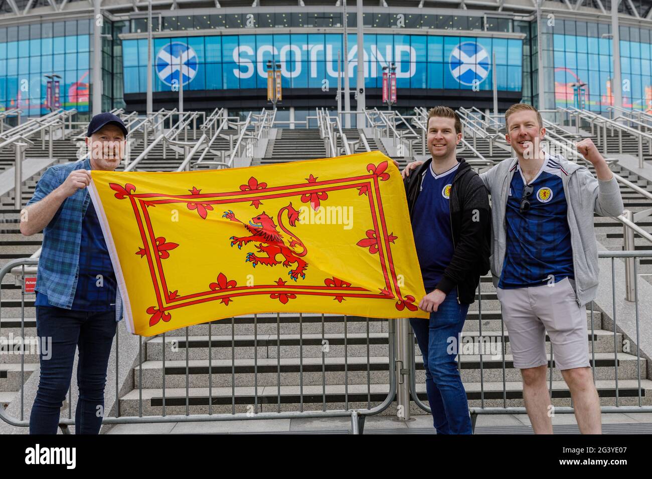 Wembley Stadium, Wembley Park, UK. 18th June, 2021. Scotland fans arrived in Wembley early this morning, despite torrential rain across London. Alan, Niall and Callum travelled from Scotland yesterday to spend the day soaking up the atmosphere in London. Scotland will face England in their 2nd Group D match of the UEFA European Football Championship at Wembley Stadium this evening with an 8pm kick off. Credit: amanda rose/Alamy Live News Stock Photo