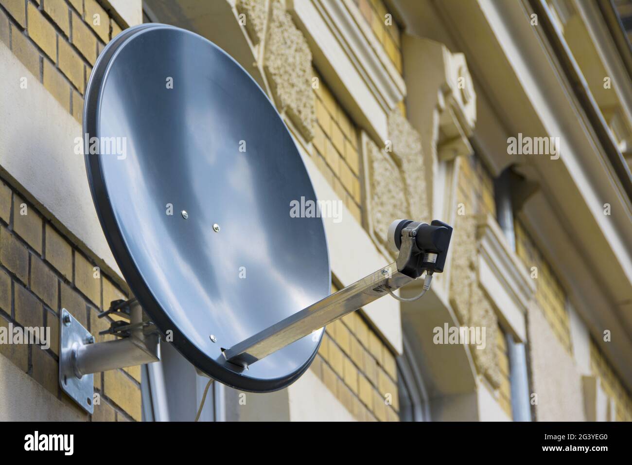 Satellite dish on the wall of a house Stock Photo