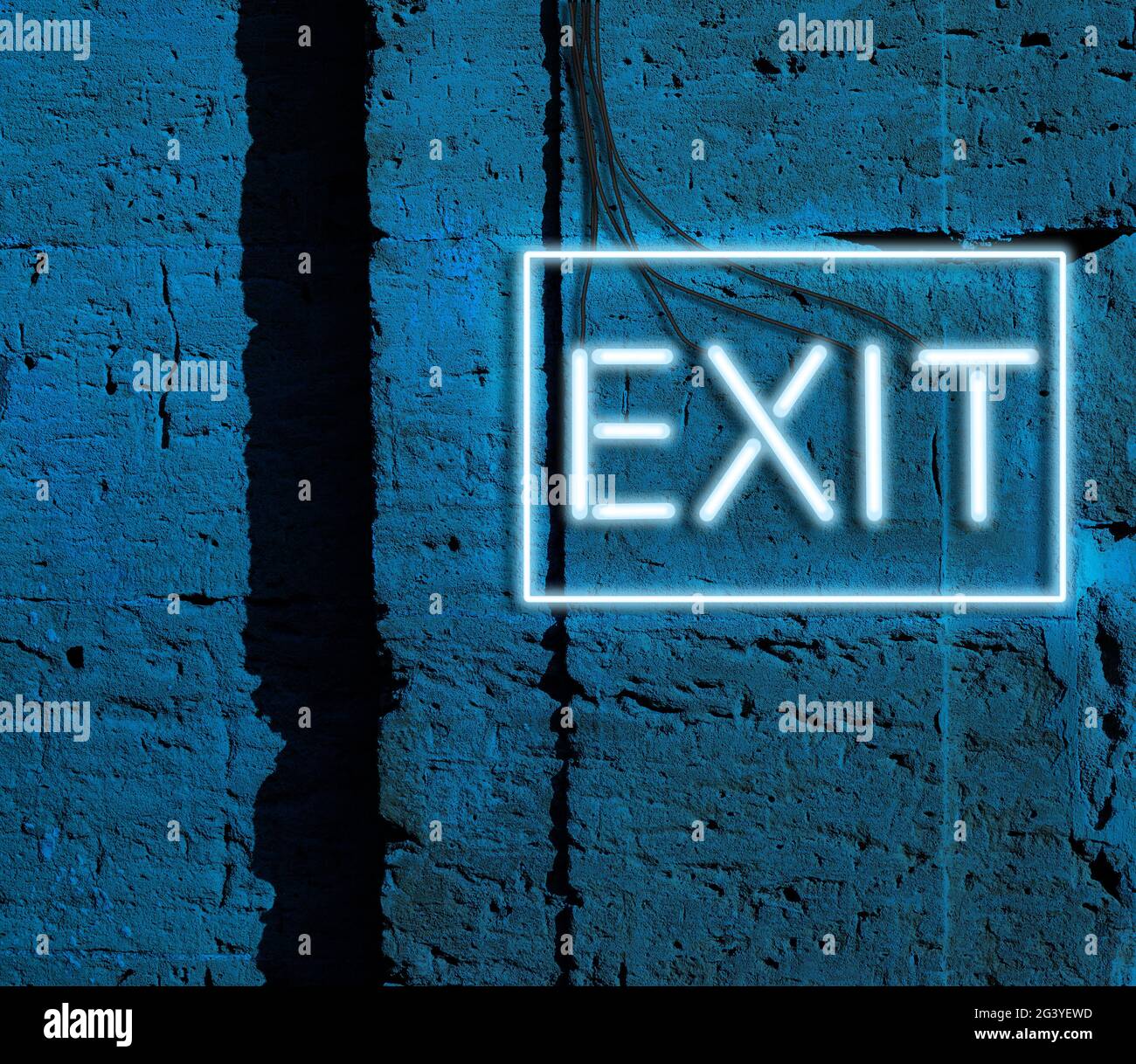 Inscription exit from glowing neon blue lamps hangs on a brick wall Stock Photo