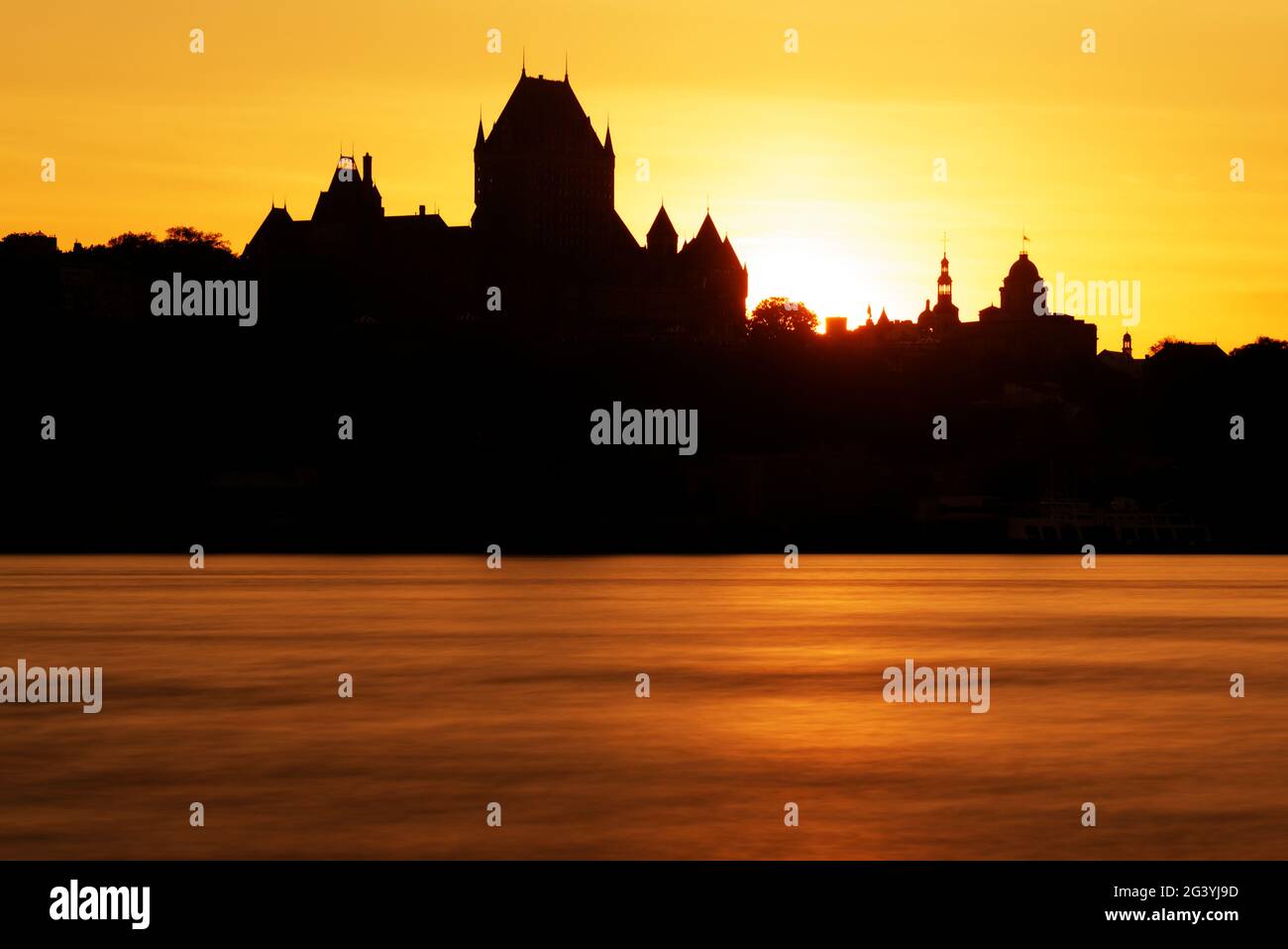 The Chateau Frontenac silhouetted against a dramatic sunset, as seen from Lévis, Quebec, Canada Stock Photo