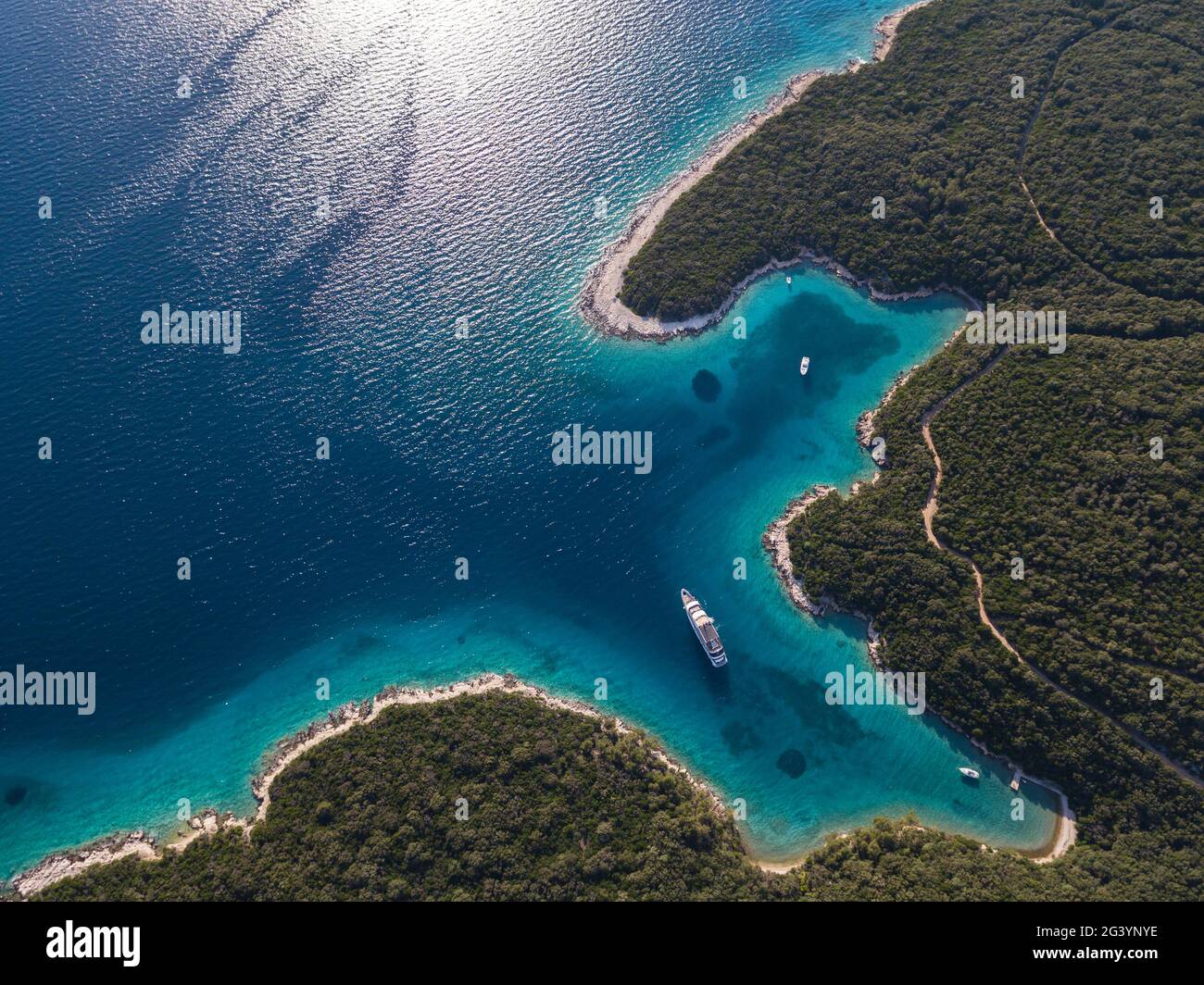 Aerial view of cruise ship in pristine bay at a swim stop for ...