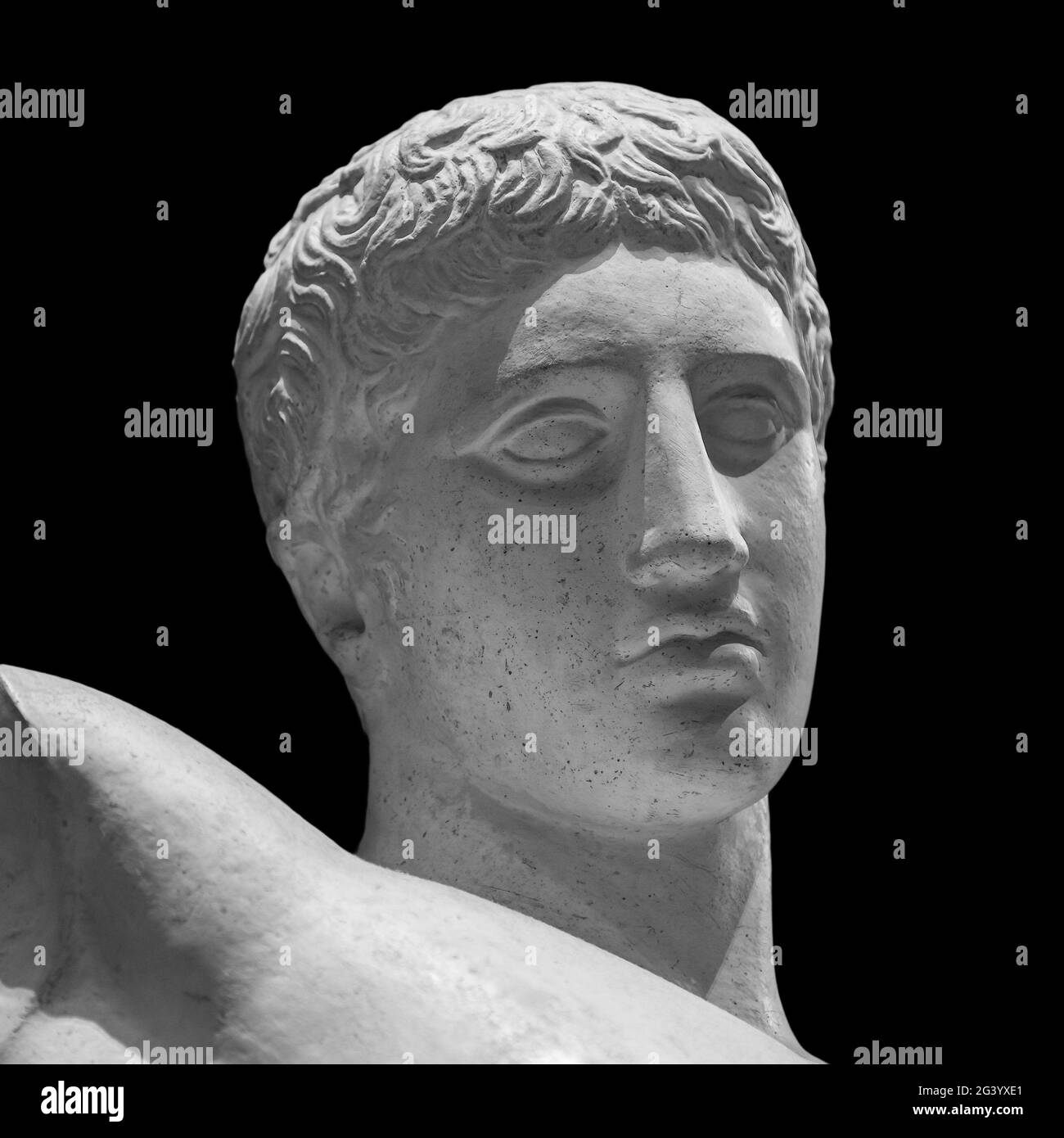 Head detail of the ancient man sculpture. Stone face isolated on black background. Antique