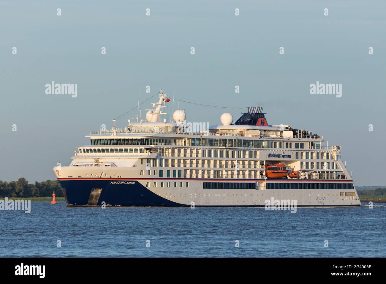 Stade, Germany - June15, 2021: Expedition cruise ship HANSEATIC NATURE on Elbe river on a voyage to Norway Stock Photo