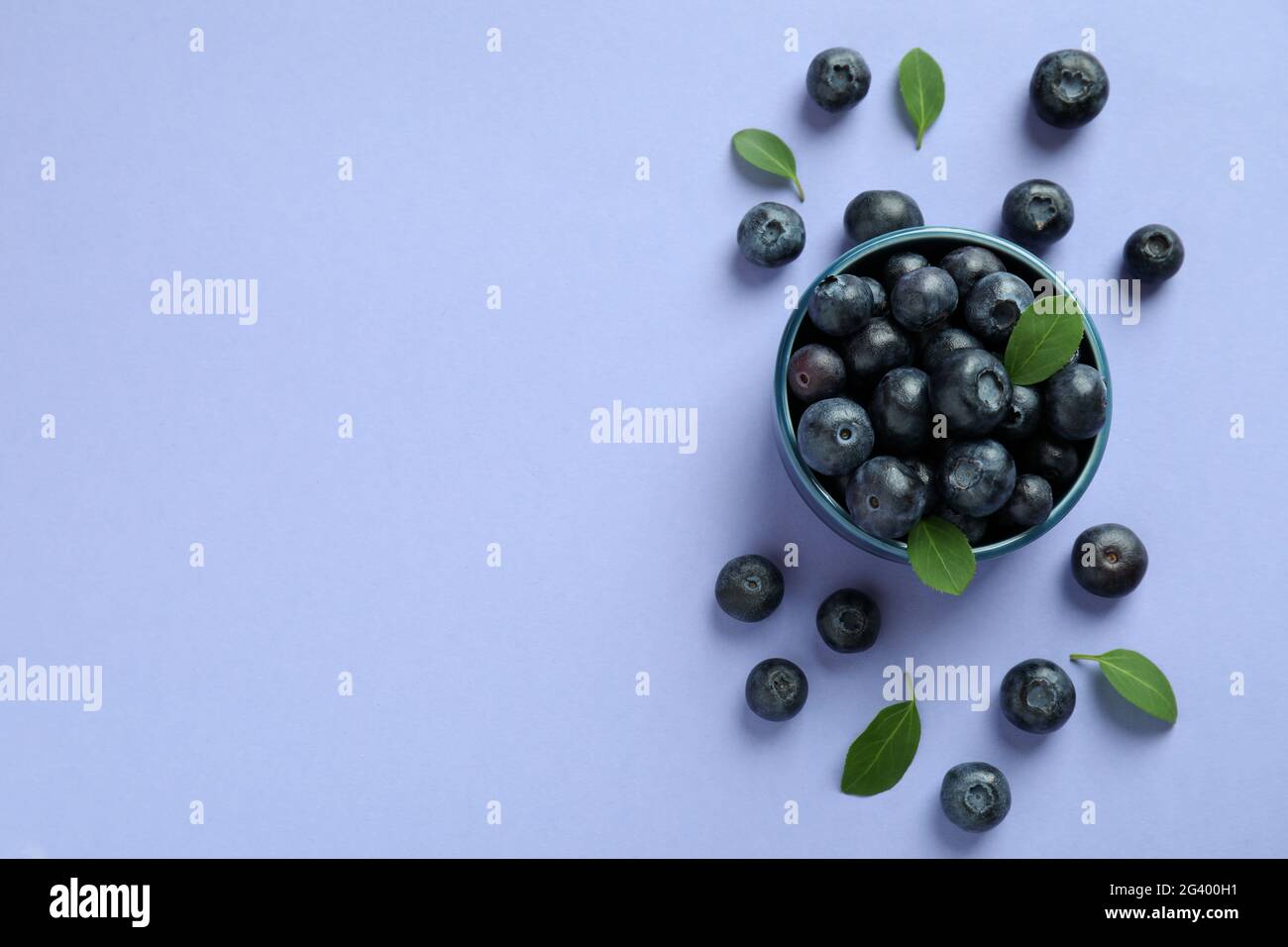 Fresh berry concept with blueberry on violet background Stock Photo - Alamy