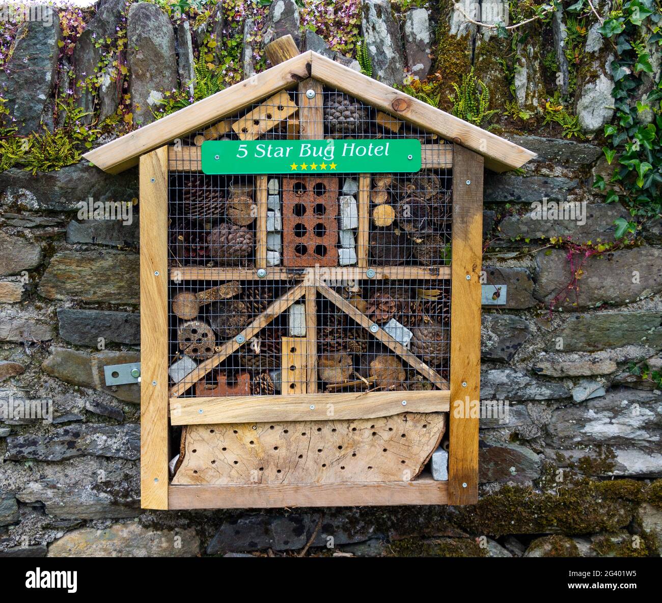 Insect hotel on garden wall Stock Photo