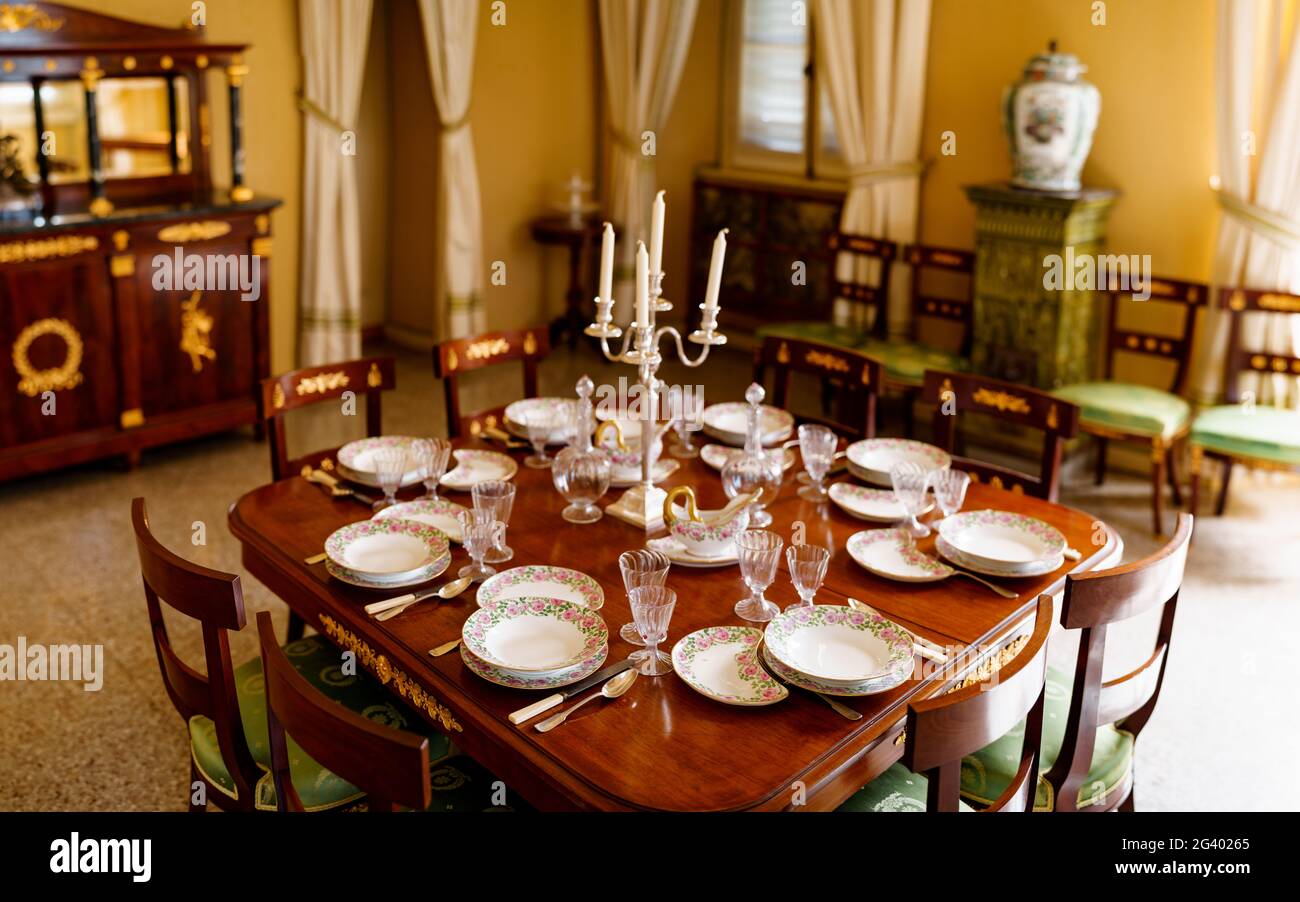 Bellagio, Italy - 07 august 2020: General view of a room with a festive table setting for serving fish dishes with clean empty p Stock Photo