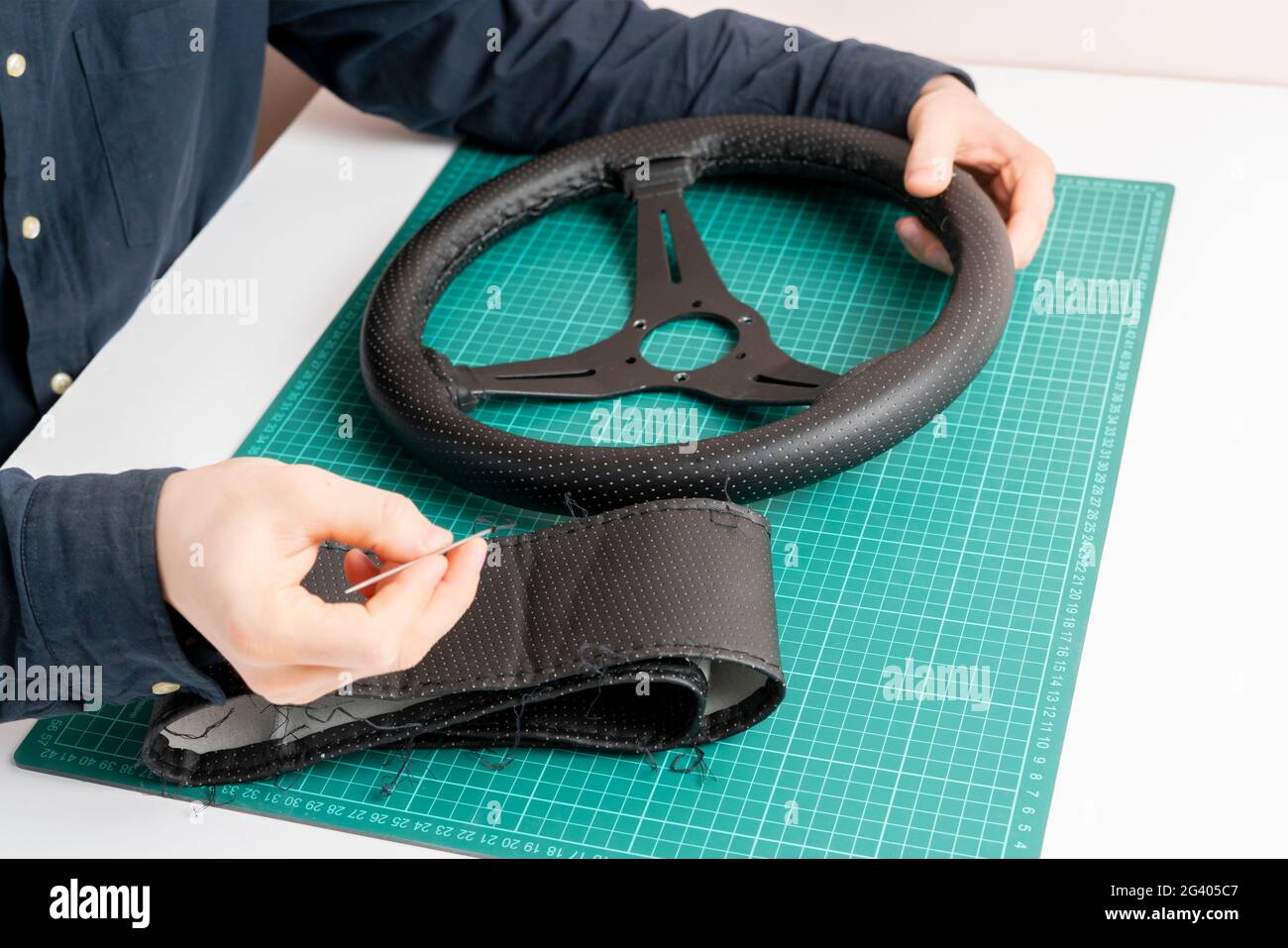 replace the car steering wheel eco leather trim material Stock Photo