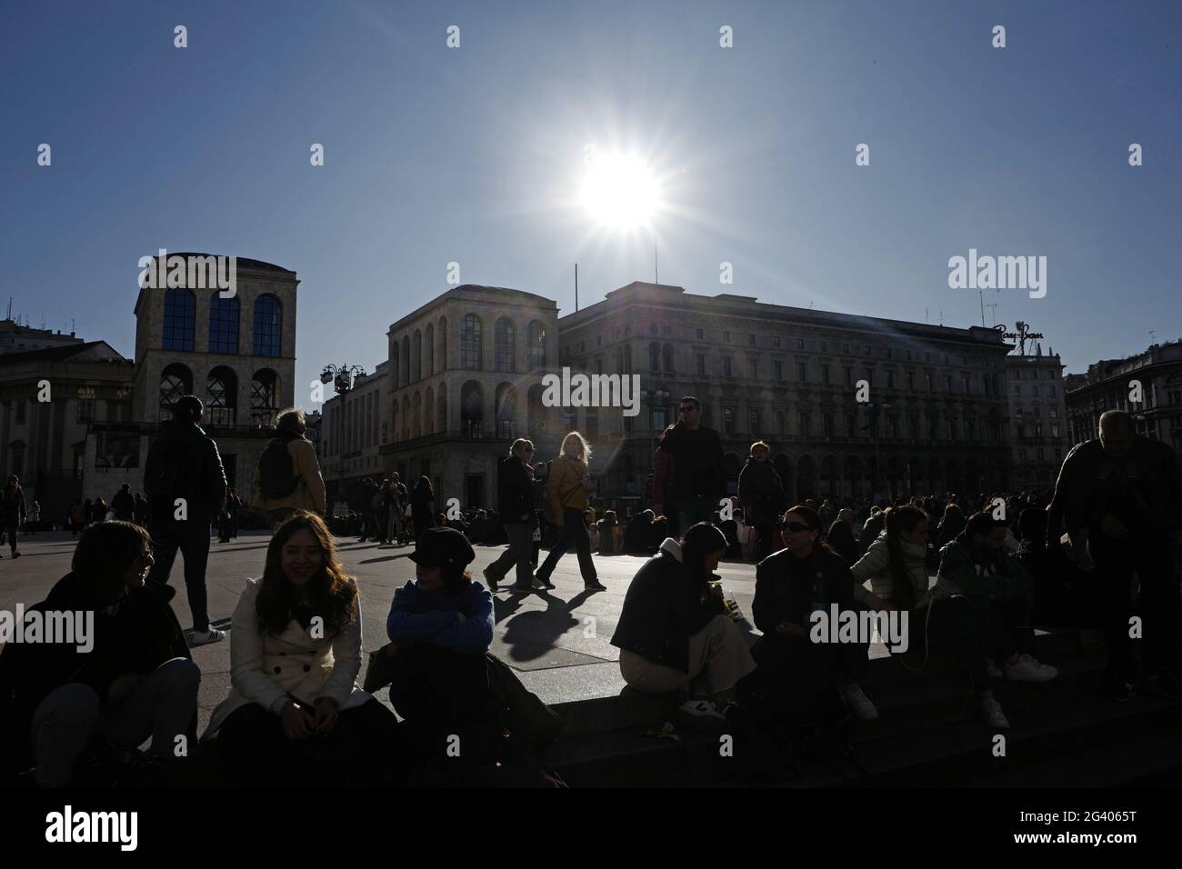 People seat on Duomo's cathedral steps, in downtown, Milan, Italy. Stock Photo