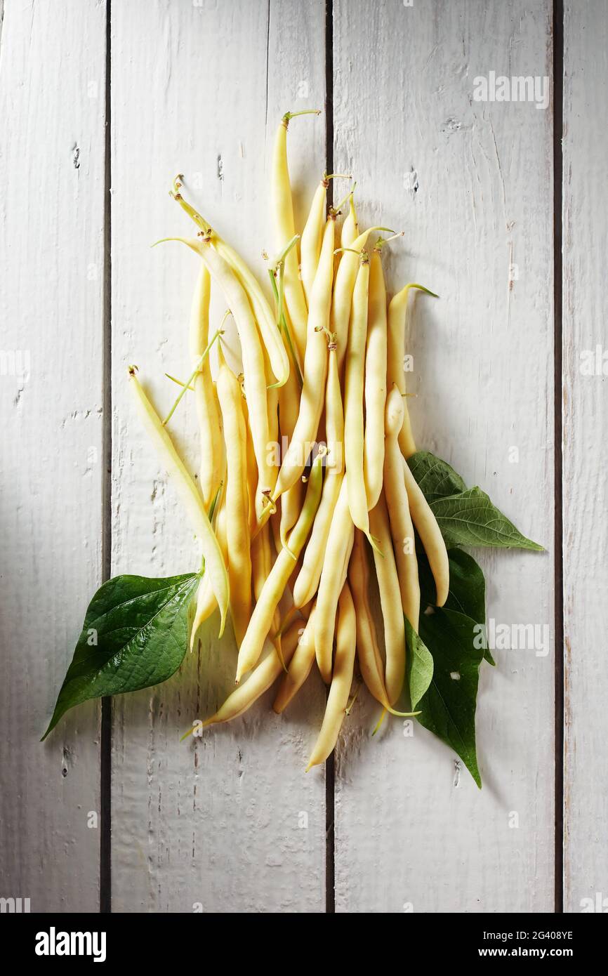 Yellow wax beans on a white wooden table. Stock Photo