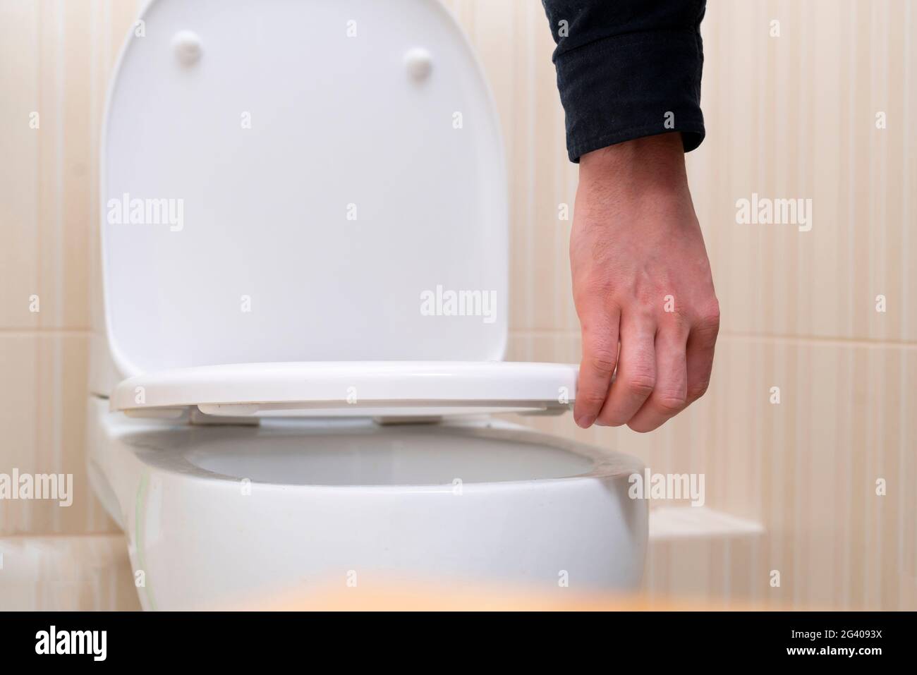 hand open the toilet lid, home household sanitary Stock Photo Alamy