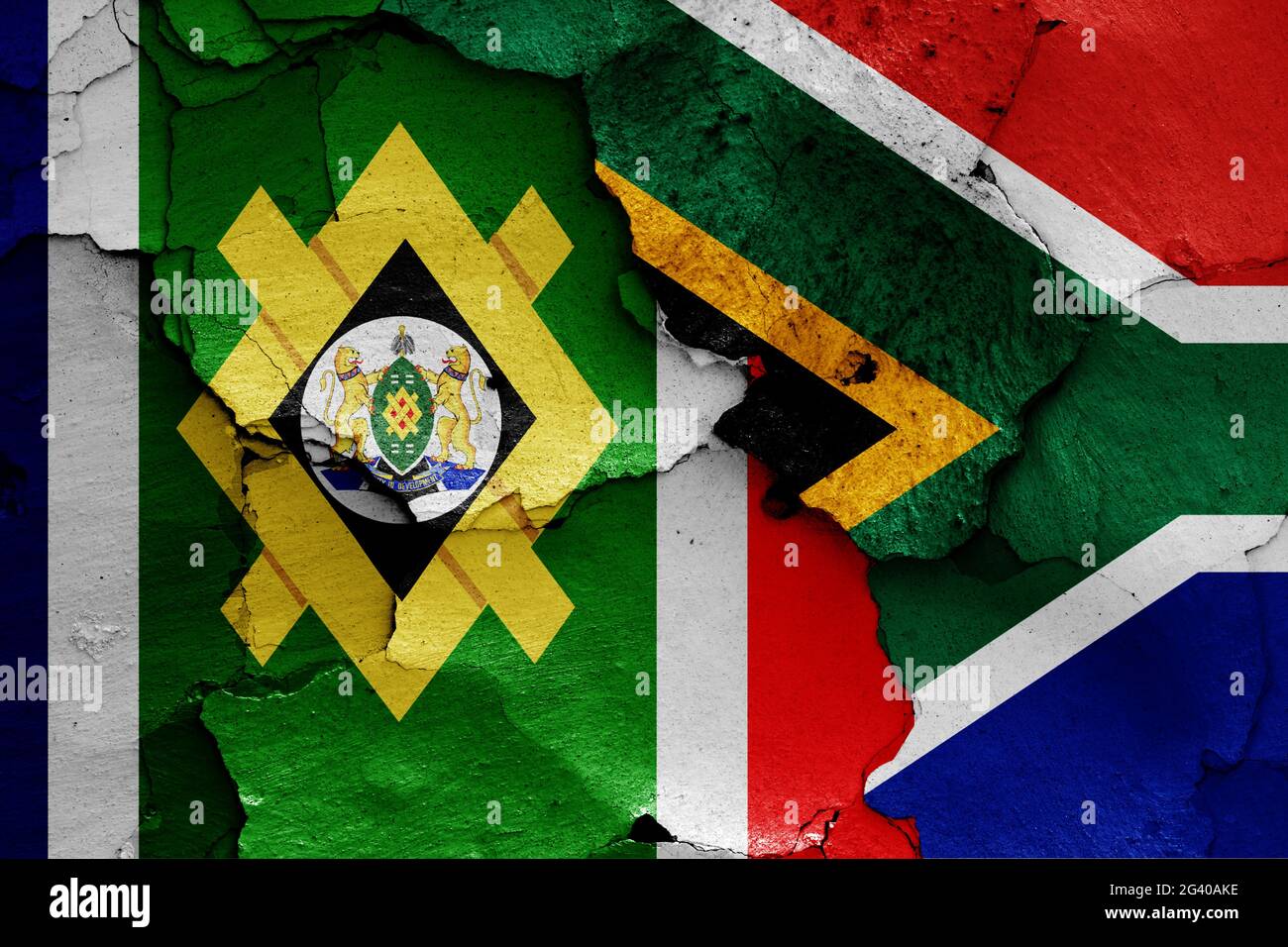 Flags of Johannesburg and South Africa painted on cracked wall Stock