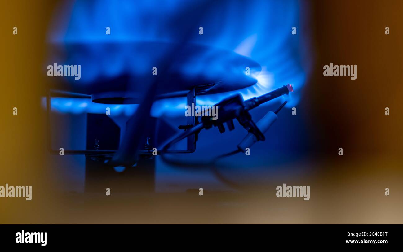 Pilot light auto igniter inside a hot water heater with flames Stock