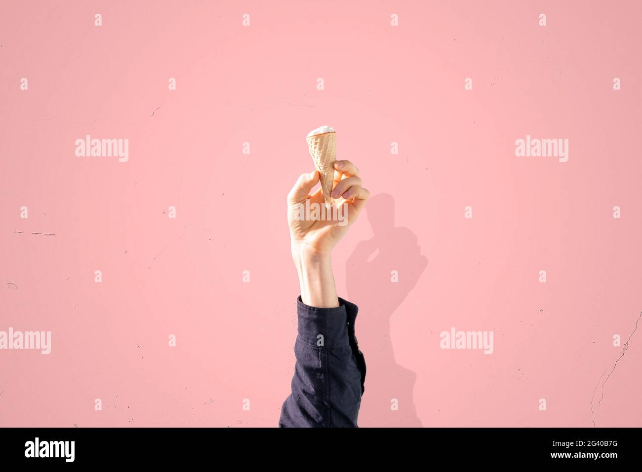 human hand holding ice cream cone isolated on color pastel background ...