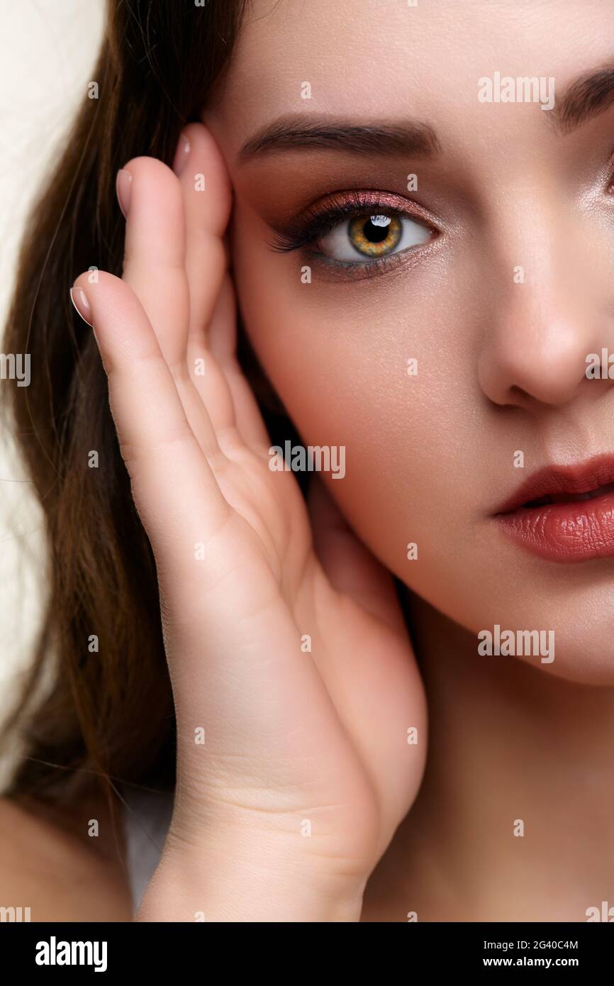 Beauty portrait of young woman. Brunette girl with evening female makeup. Stock Photo